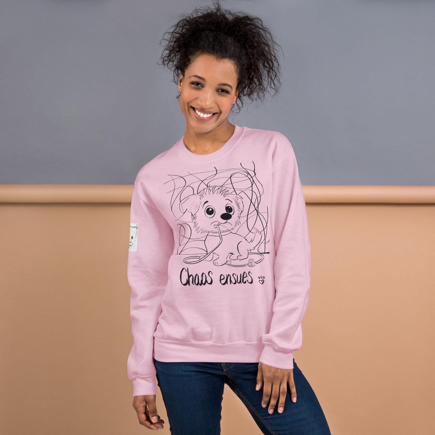 Chaos Ensues pink sweatshirt with funny chaotic vet med dog design on model – GrungePup Vet Chaos humor apparel for vet techs