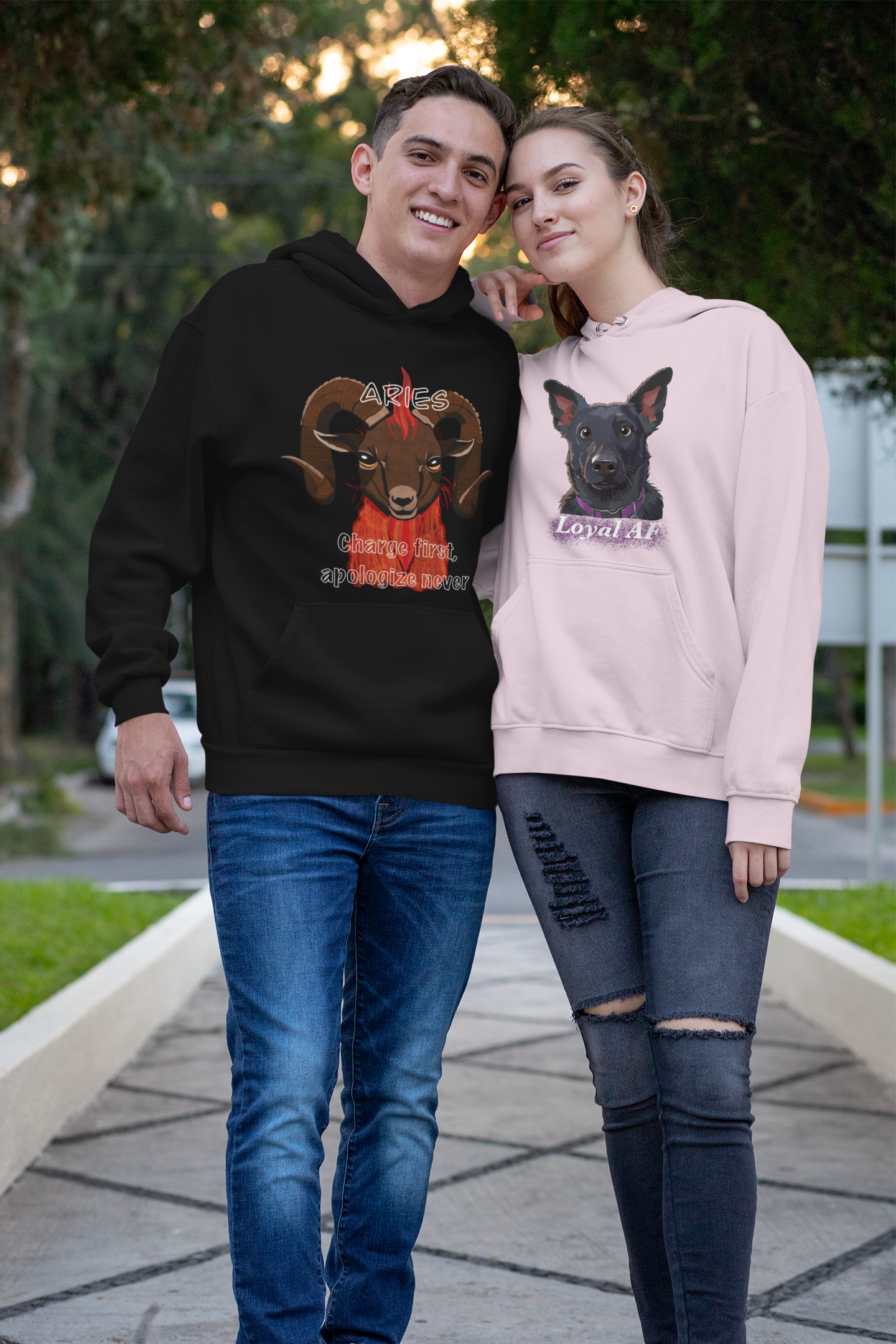 Happy couple standing in park, woman wearing light pink Mathis Loyal AF hoodie and man wearing Aries hoodie