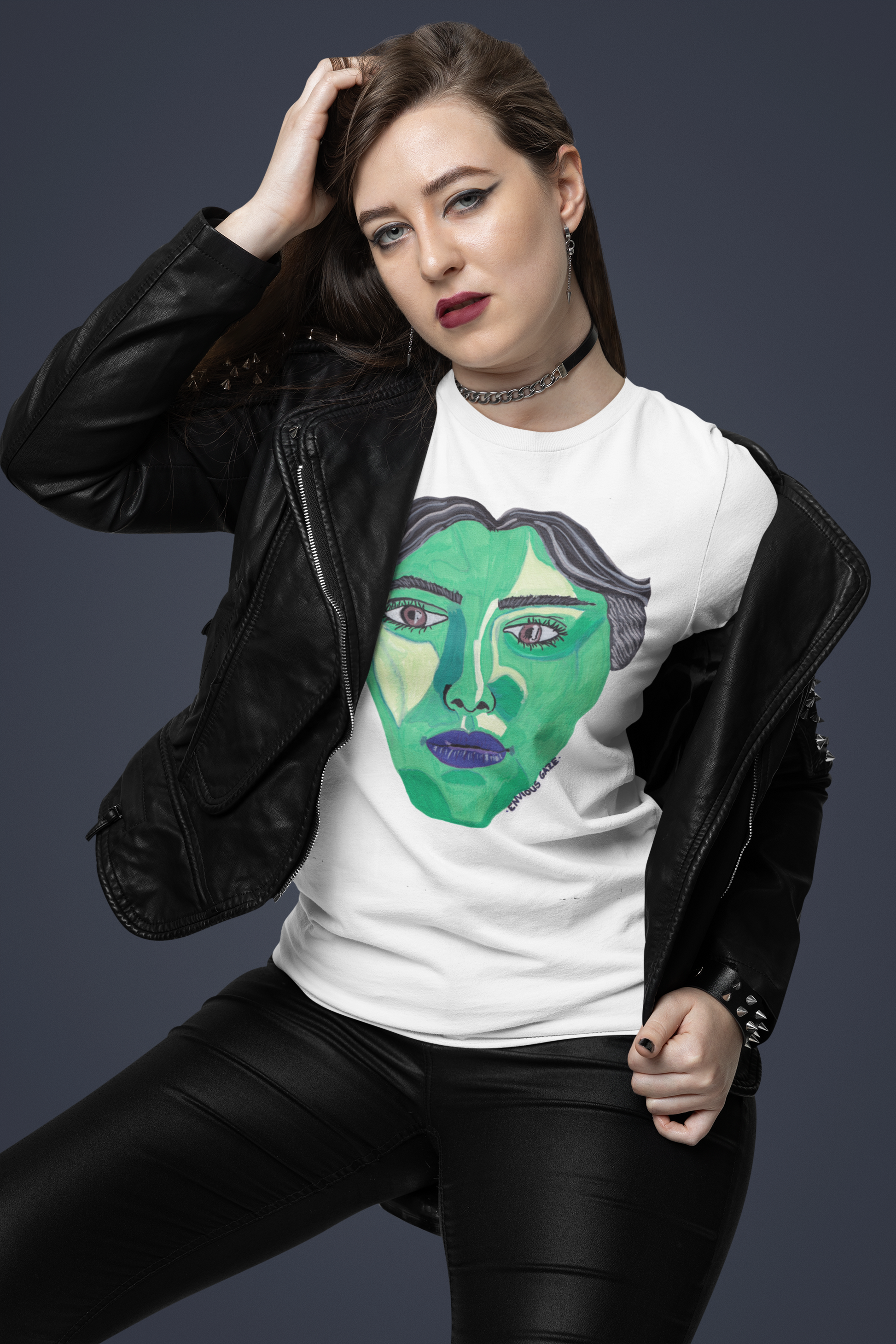 Woman in white Envious Gaze t-shirt and black leather jacket posing with intense expression