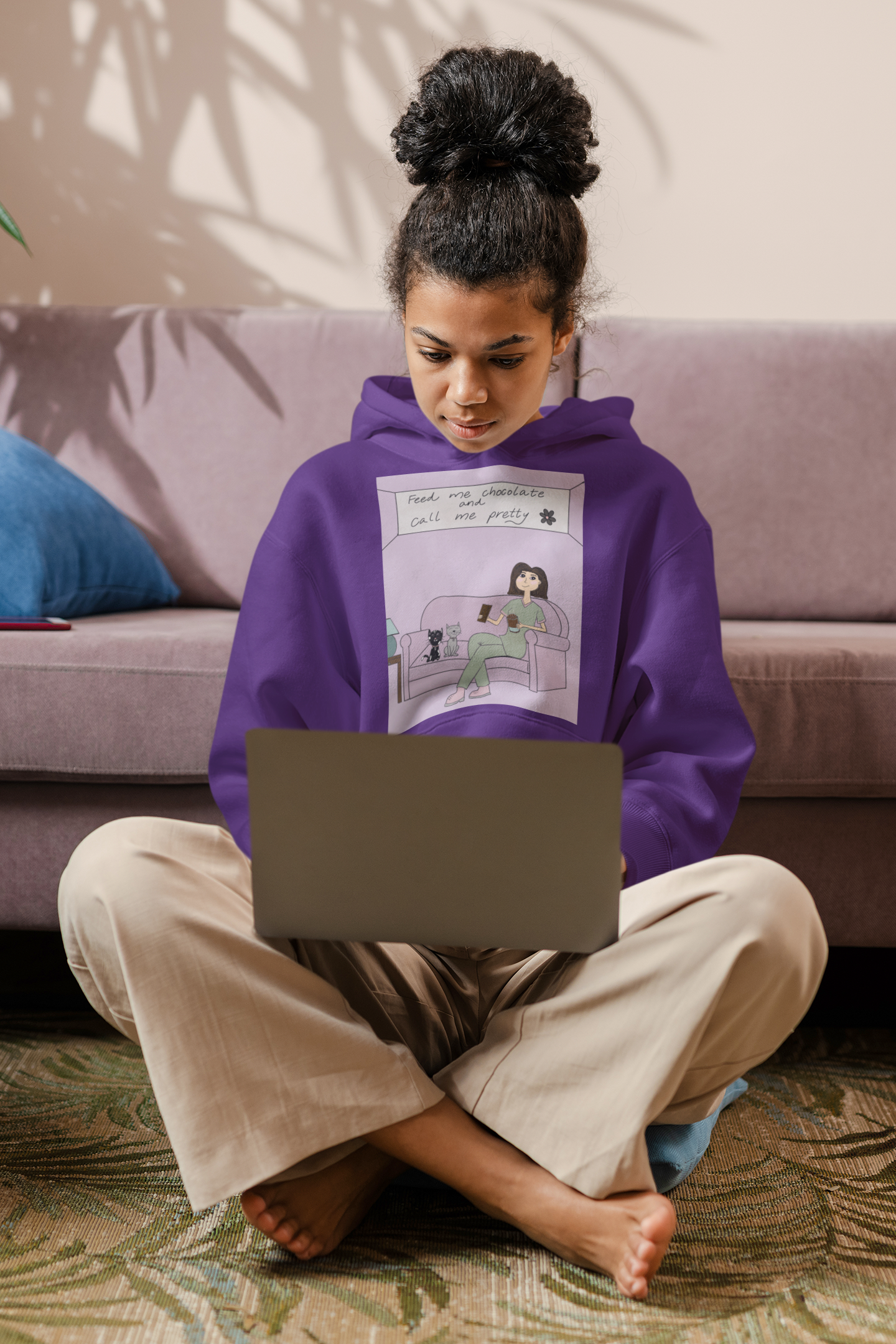 Woman sitting in front of couch wearing purple "Feed Me Chocolate and Call Me Pretty" hoodie – GrungePup Sarcastic Affirmations lazy vibes design