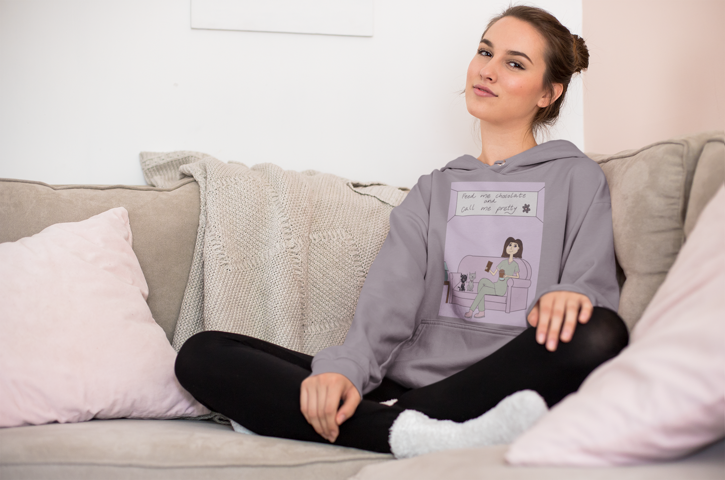 Woman sitting cross-legged on couch wearing sport grey "Feed Me Chocolate and Call Me Pretty" hoodie – GrungePup Sarcastic Affirmations lazy vibes