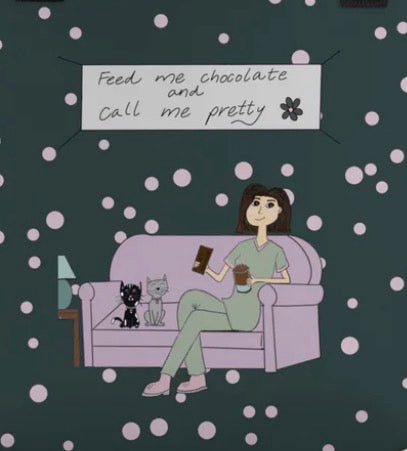 Close-up of Feed Me Chocolate and Call Me Pretty tote bag design featuring cartoon woman on couch with cats and speech bubble