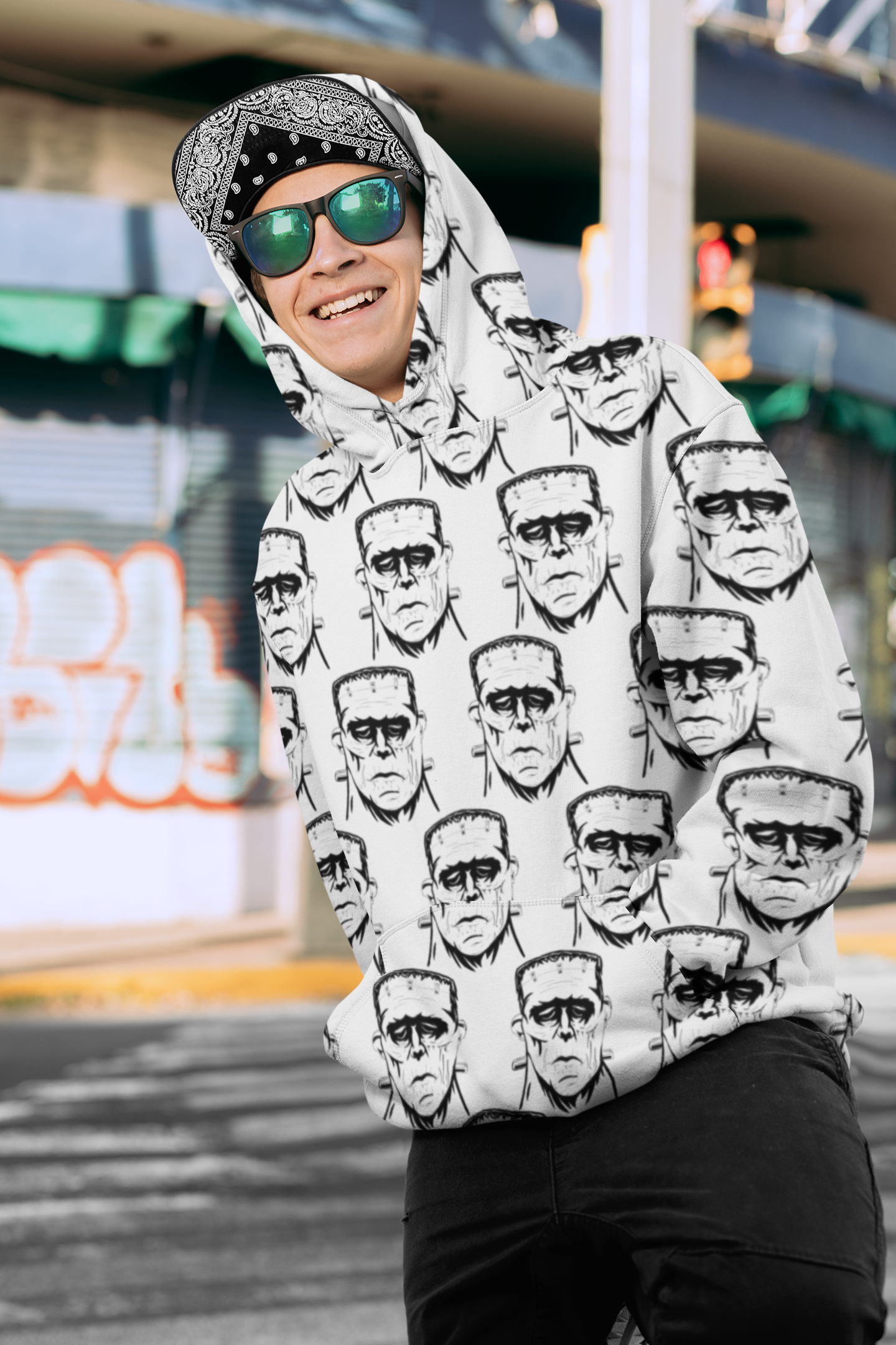 Man wearing bandana and sunglasses in Frank's Monster all-over print hoodie standing outdoors
