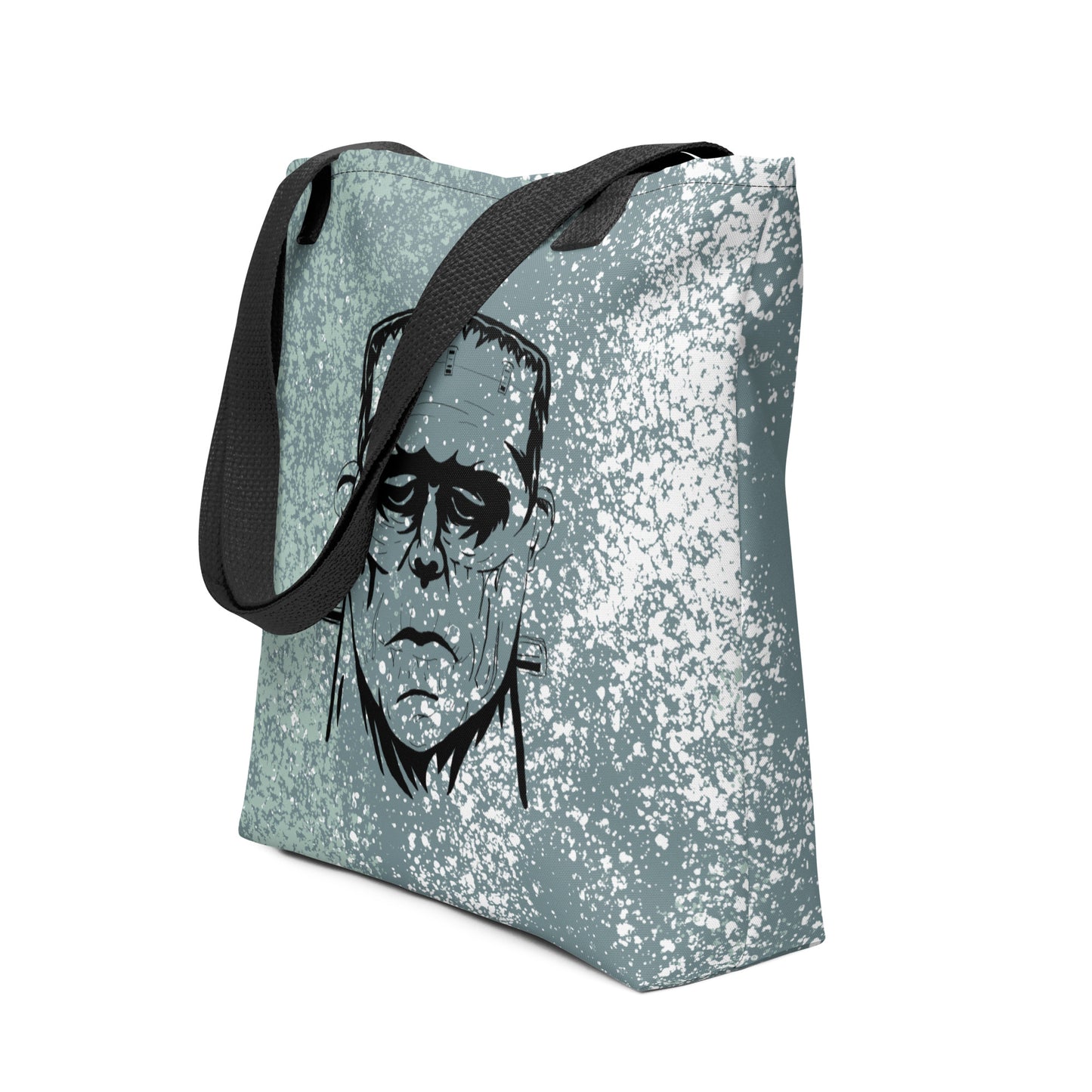 Side view of Frank's Monster all-over print tote bag with black straps and repeating horror face design
