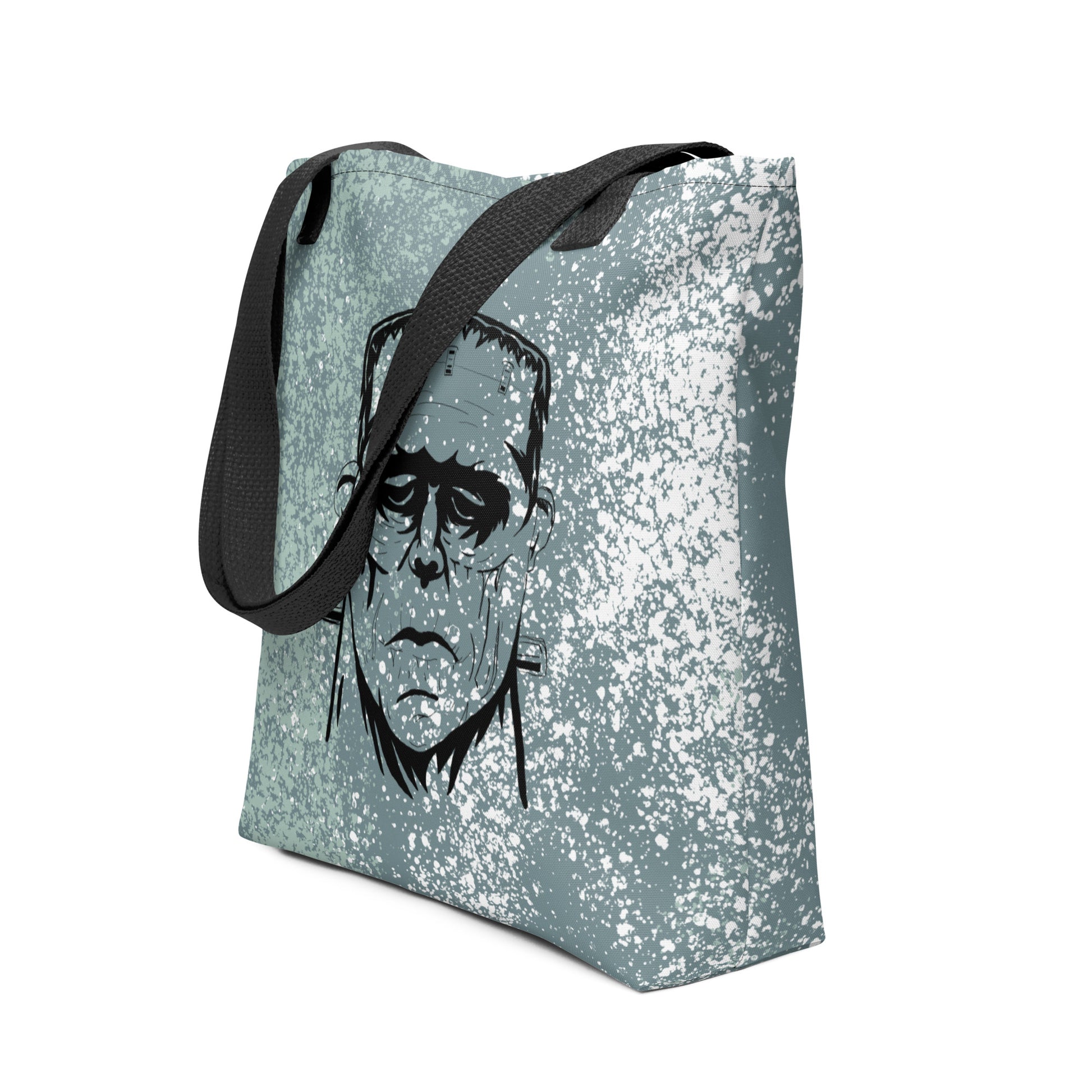 Side view of Frank's Monster all-over print tote bag with black straps and repeating horror face design