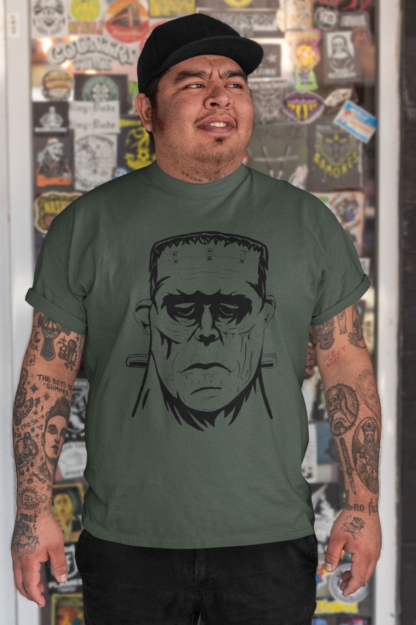 Man wearing heather forest green Frank's Monster t-shirt with bold Frankenstein face design