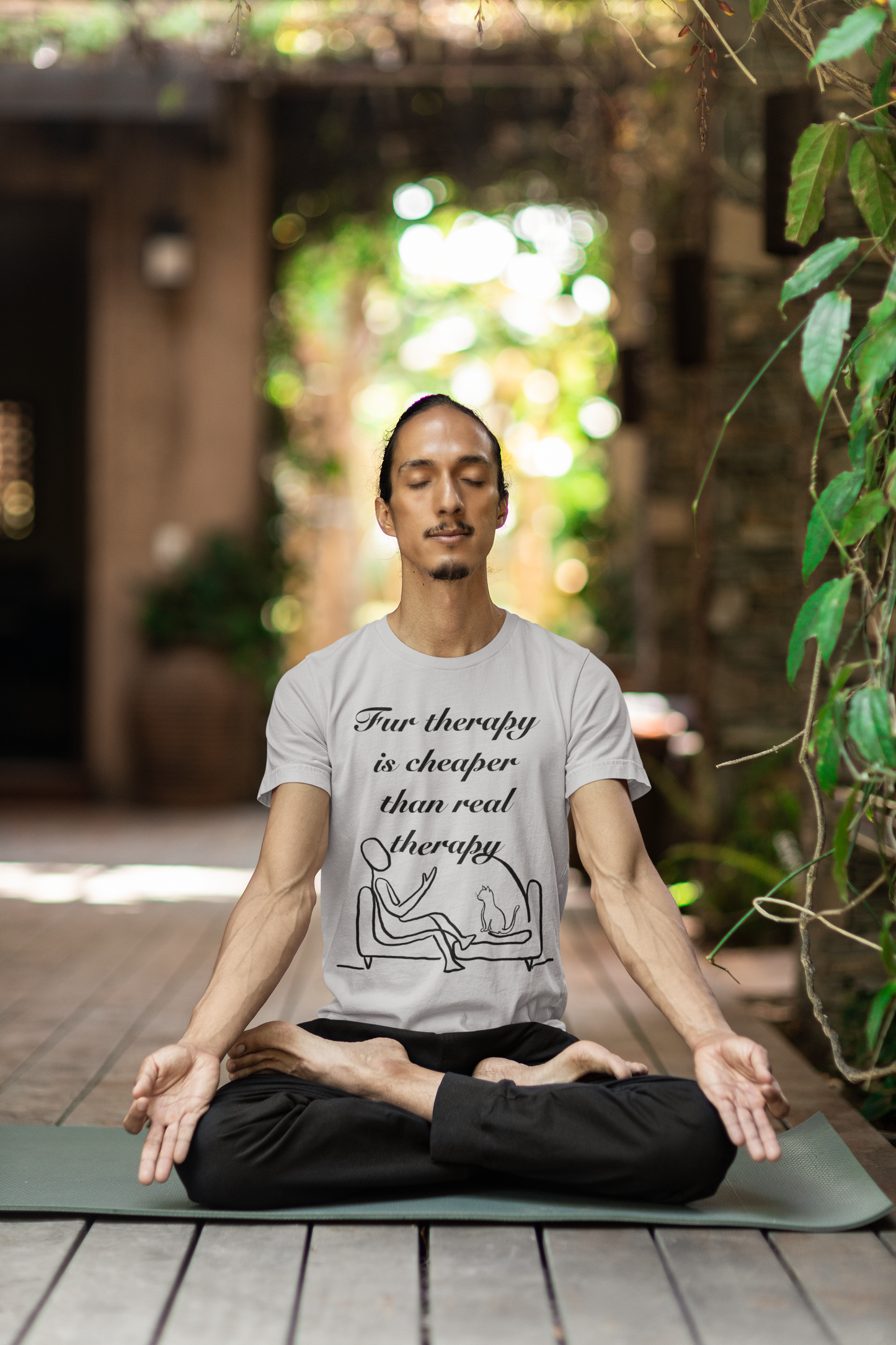 Man sitting cross-legged wearing athletic heather Fur Therapy is Cheaper Than Real Therapy black ink cat t-shirt