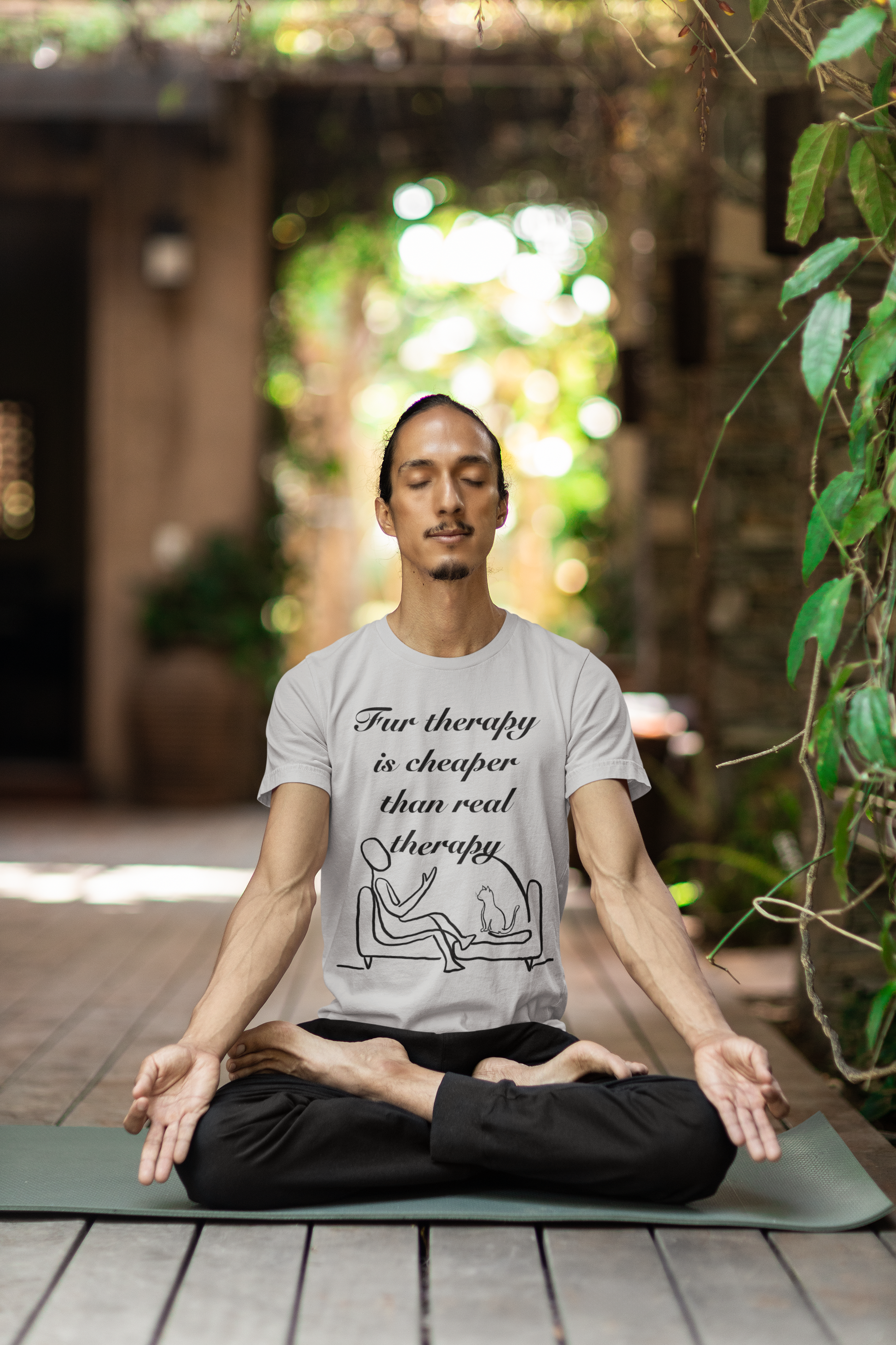 Man sitting cross-legged wearing athletic heather Fur Therapy is Cheaper Than Real Therapy black ink cat t-shirt