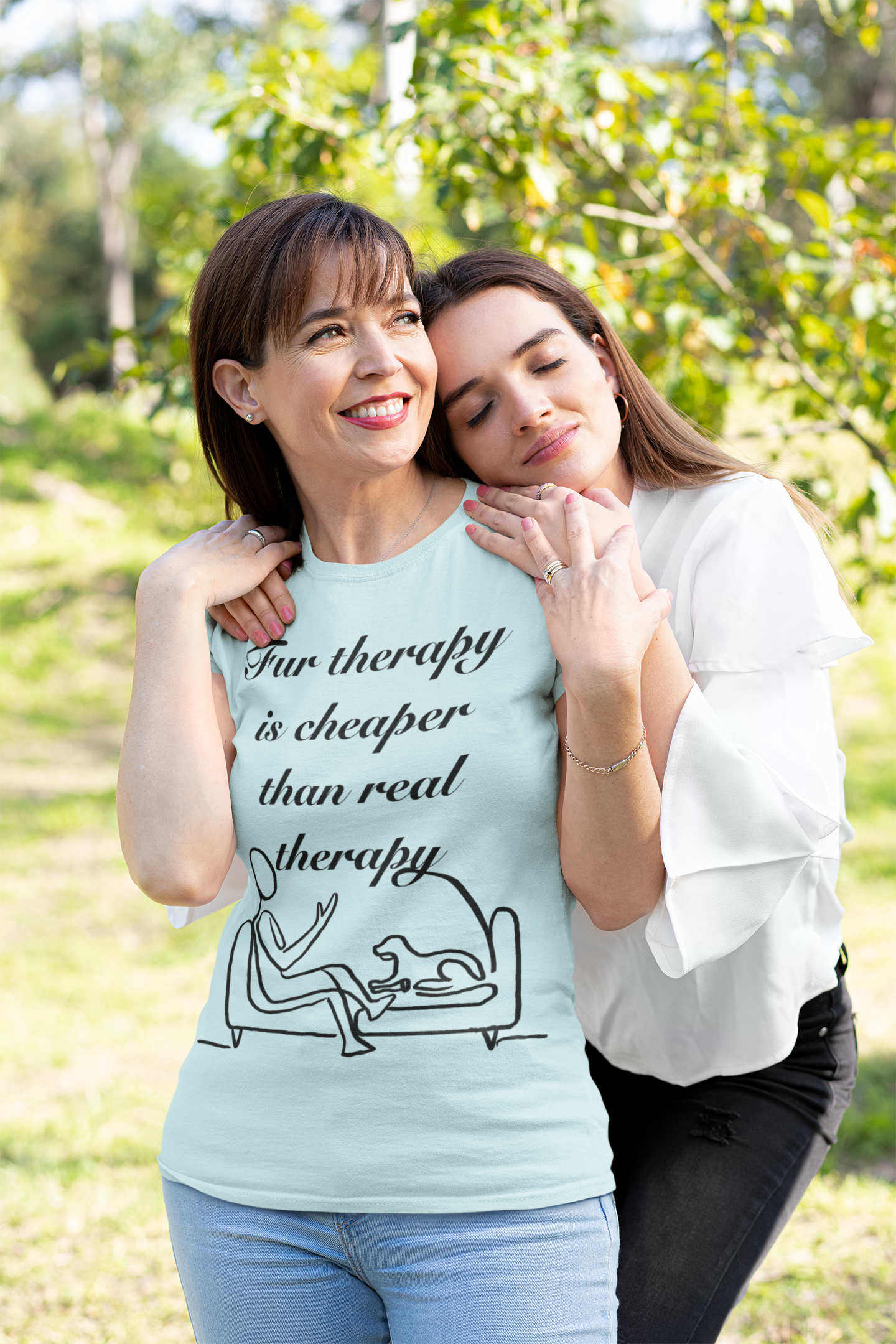 Smiling woman in heather prism ice blue t-shirt being hugged by her daughter outdoors