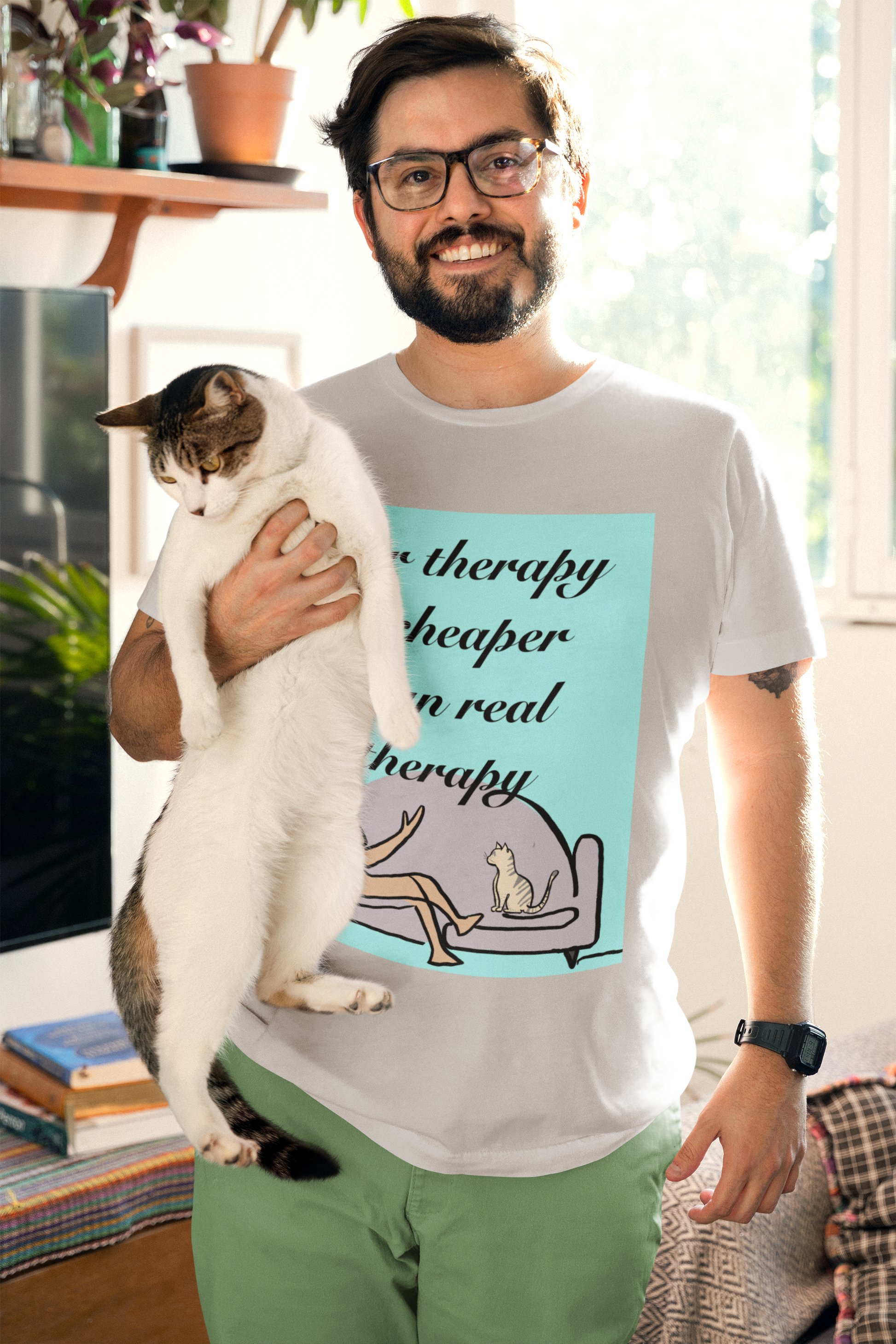 Man with glasses holding a cat wearing athletic heather Fur Therapy Is Cheaper Than Real Therapy colored cat t-shirt – relatable pet therapy humor by GrungePup Sarcastic Affirmations