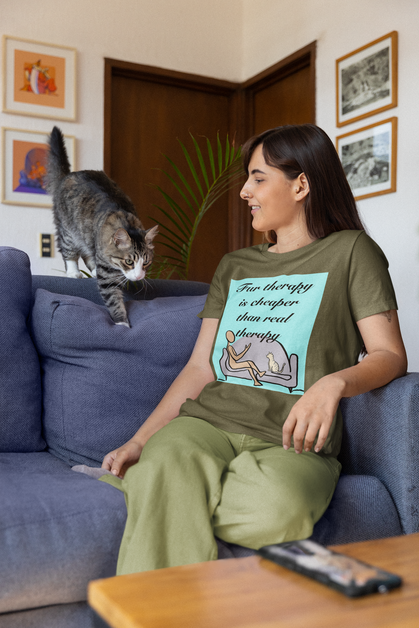 Woman sitting on couch with cat wearing heather olive Fur Therapy Is Cheaper Than Real Therapy colored cat t-shirt – sarcastic affirmation design by GrungePup Sarcastic Affirmations