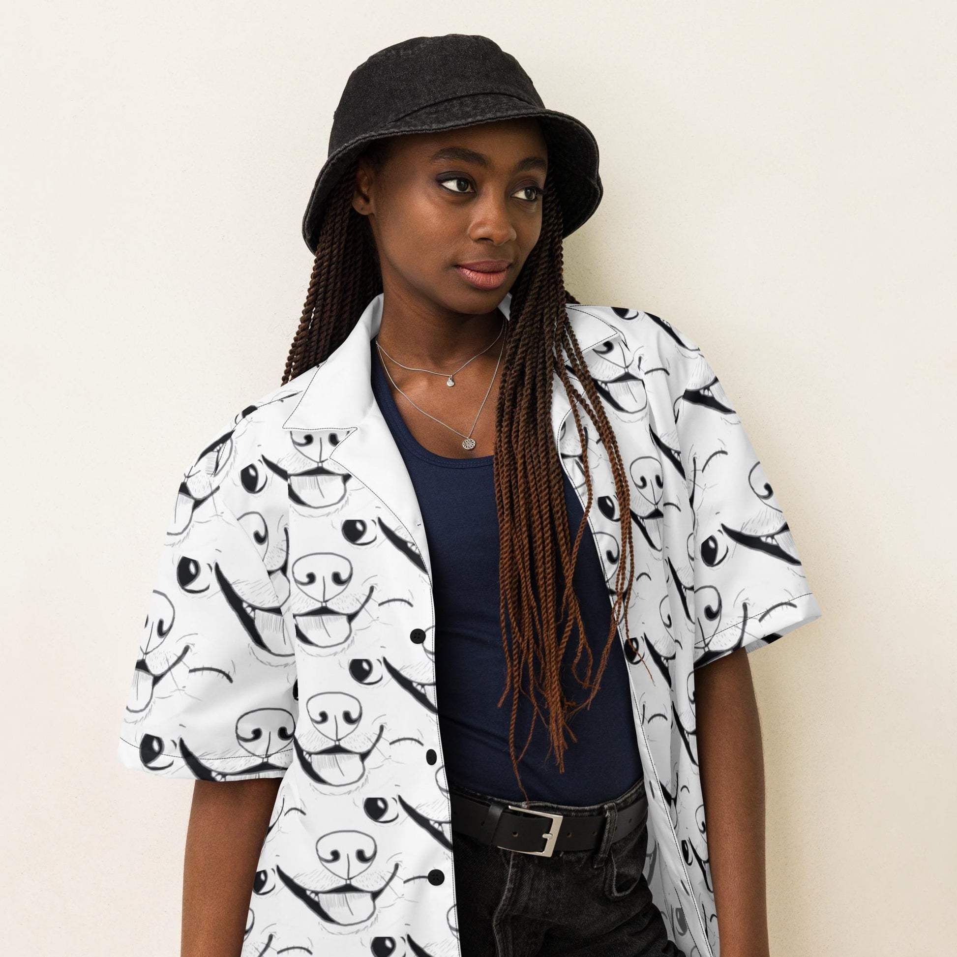 Girl with braids and hat wearing GrungePup logo all-over print button down shirt