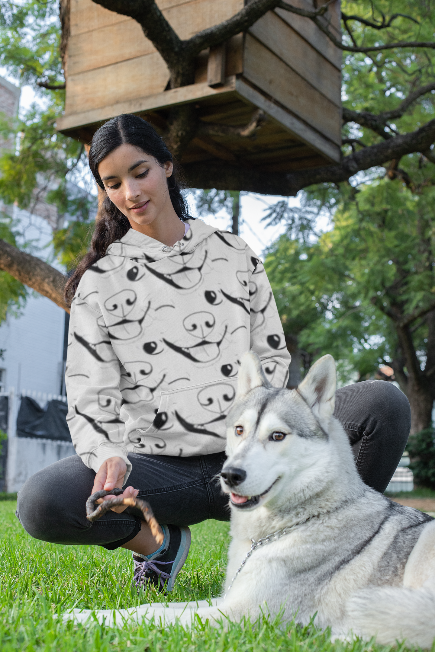 Woman sitting outdoors with her husky wearing GrungePup logo all-over print hoodie
