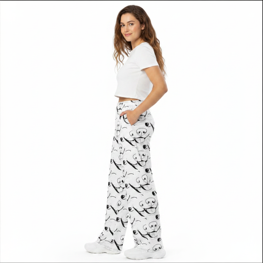 Woman with long brown hair wearing white crop top and GrungePup logo all-over print wide-leg pants