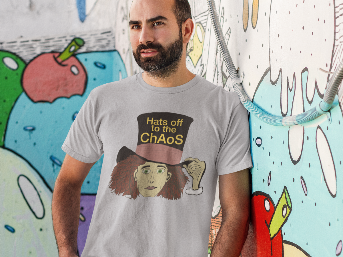 Bearded man in a sport grey Hats Off to the Chaos Mad Hatter t-shirt leaning on a colorful graffiti wall. That Girl, Alice by GrungePup Gallery.