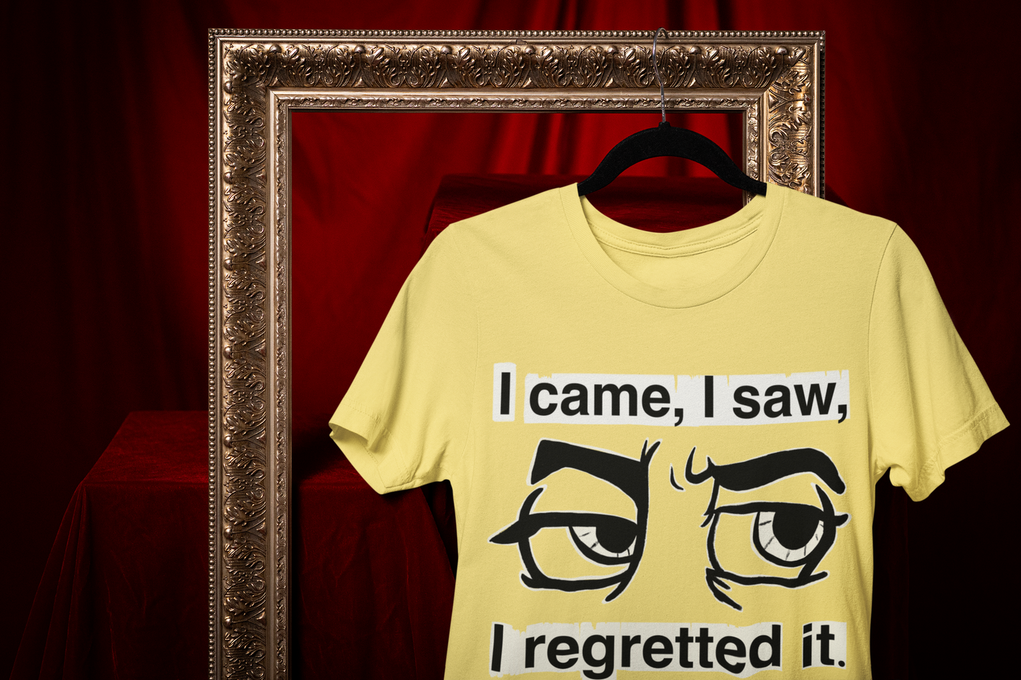 Cornsilk yellow Gildan Softstyle t-shirt with I Came I Saw I Regretted It eye-roll design hanging on a black hanger