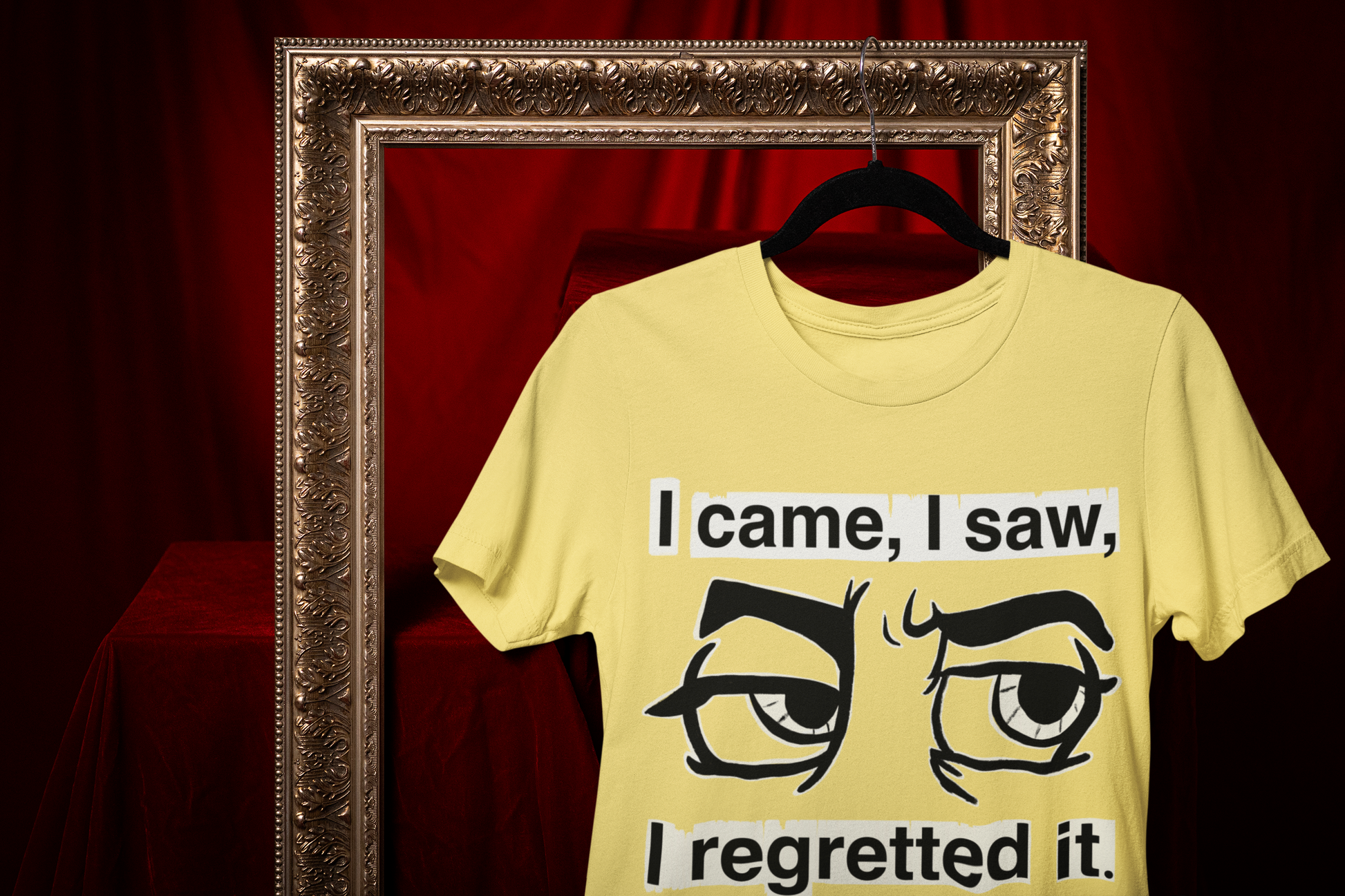 Cornsilk yellow Gildan Softstyle t-shirt with I Came I Saw I Regretted It eye-roll design hanging on a black hanger