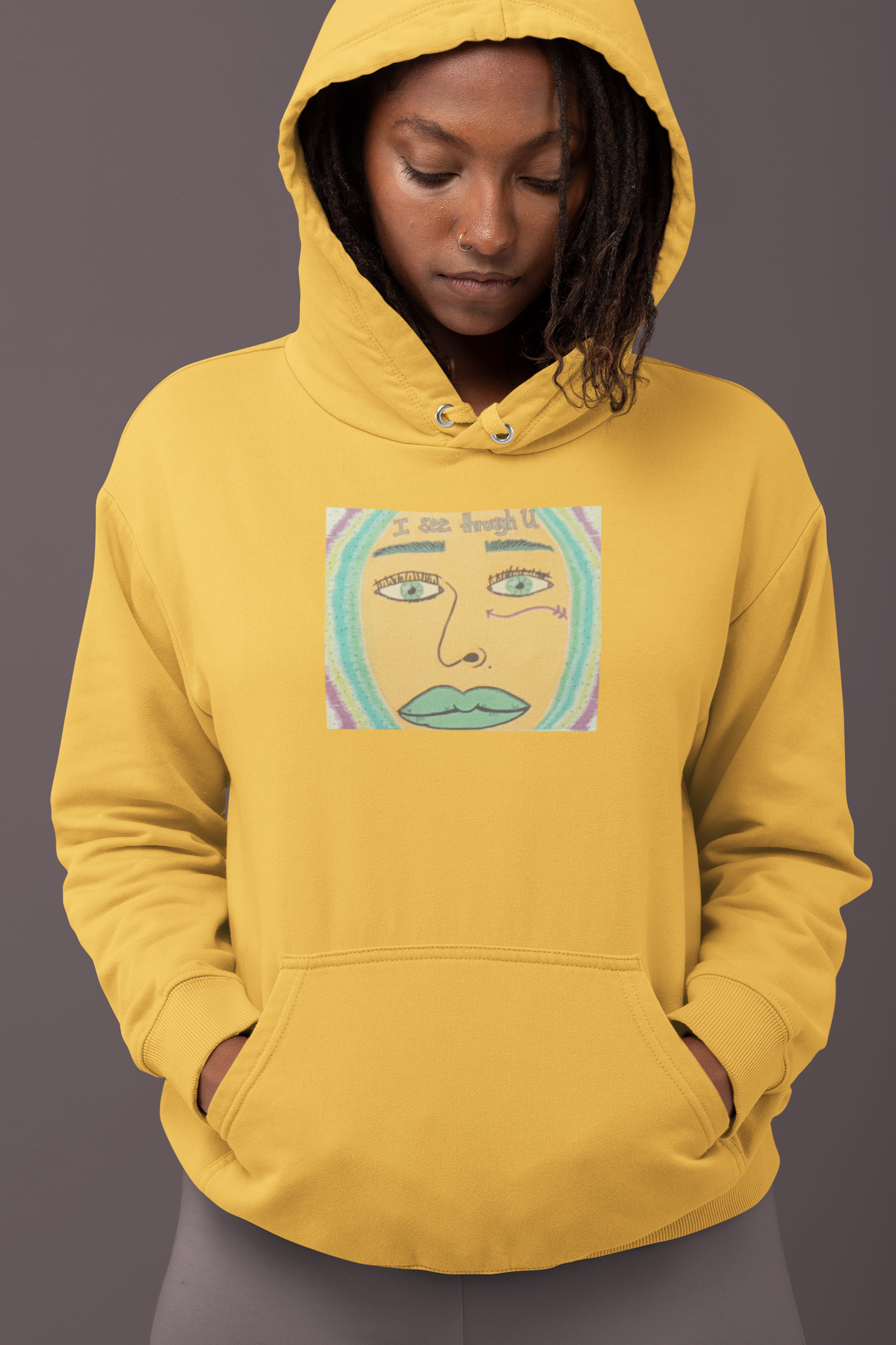Dark skinned woman wearing gold yellow I See Through U hoodie looking down with intense face design