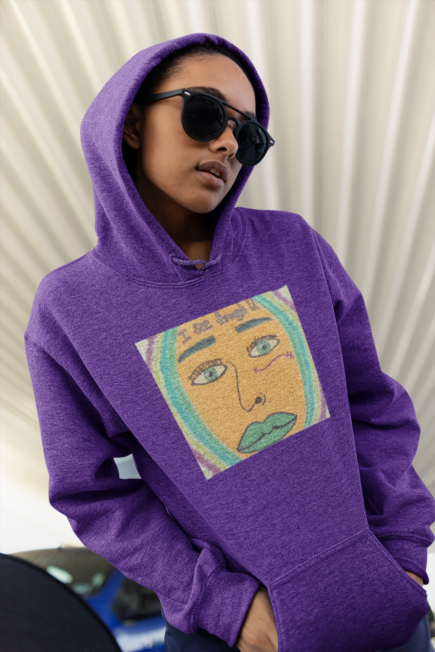 Woman wearing purple I See Through U hoodie with colorful face graphic standing in parking lot