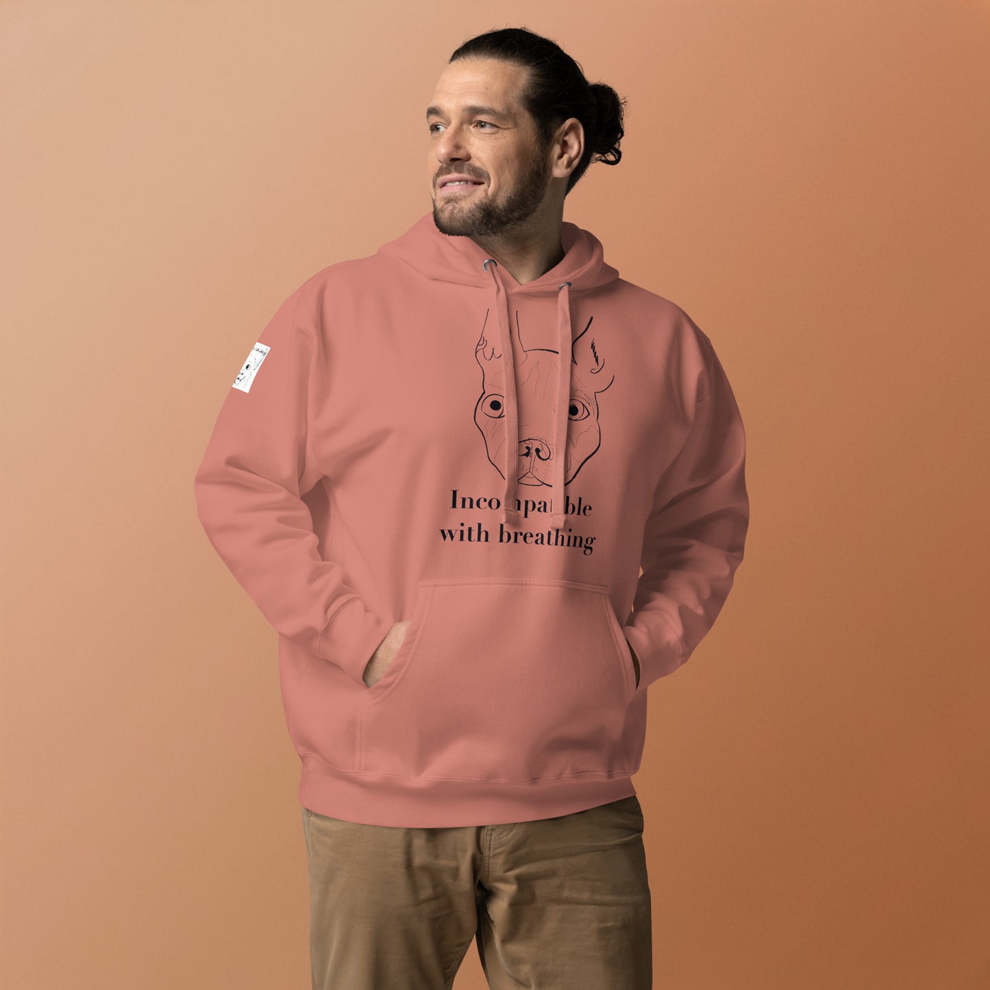Man with tied-back hair wearing dusty rose Incompatible with Breathing black ink hoodie featuring French Bulldog design