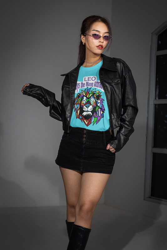 Woman in a black leather jacket and mini skirt posing near a window while wearing a turquoise Leo Always the Mane Attraction t-shirt