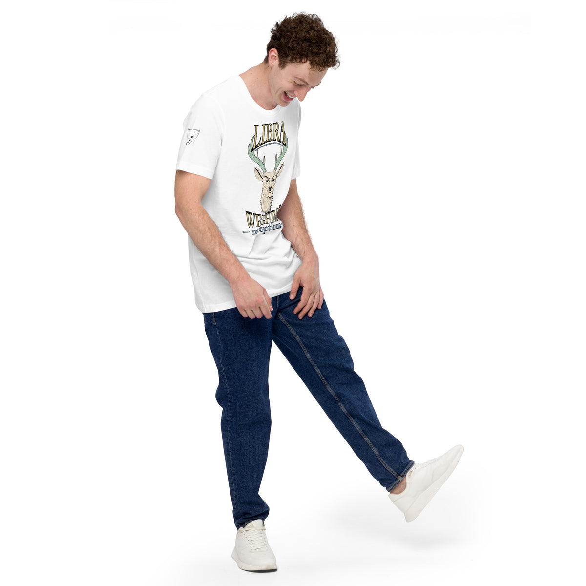 Man in a white Libra Weighing My Options tee looking down and smiling, cream stag with mint antlers and gold lettering.