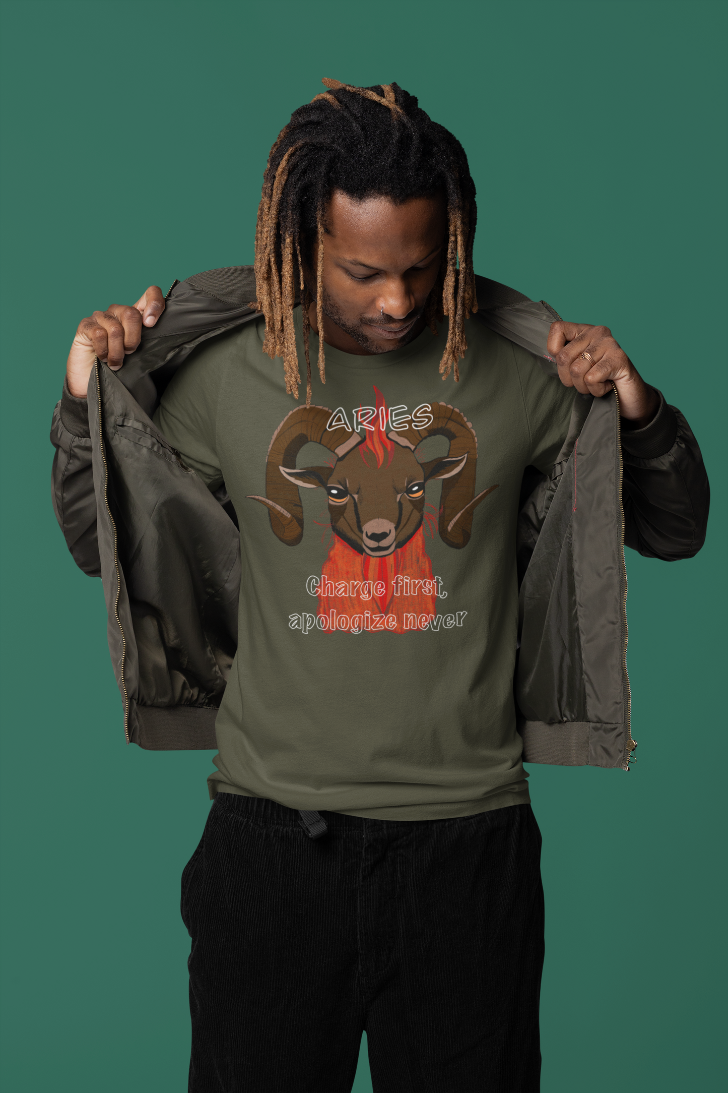 Man standing wearing an open jacket and military green Bella + Canvas t-shirt featuring the fiery Aries ram design
