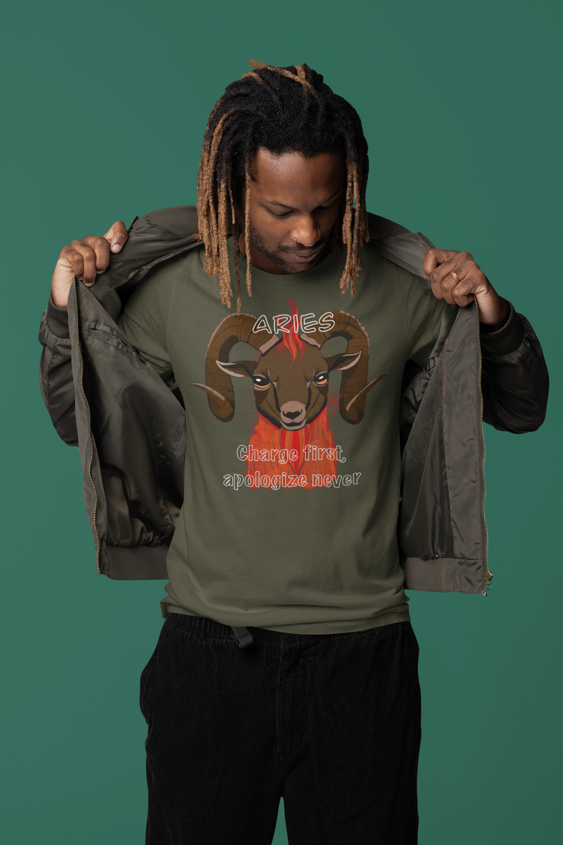 Man standing wearing an open jacket and military green Bella + Canvas t-shirt featuring the fiery Aries ram design