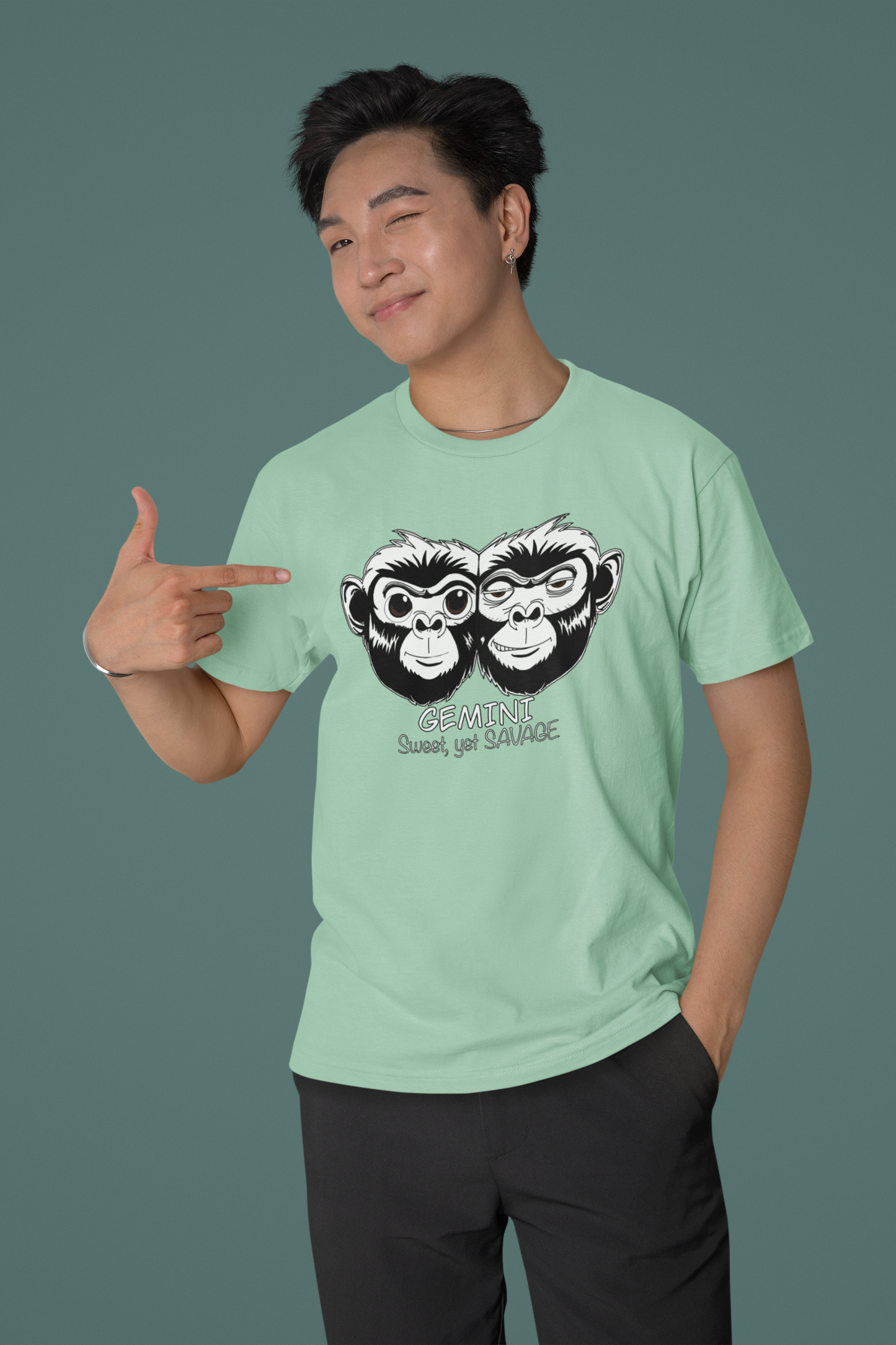 Asian man winking and pointing at his heather prism mint Bella + Canvas t-shirt with Gemini monkey design
