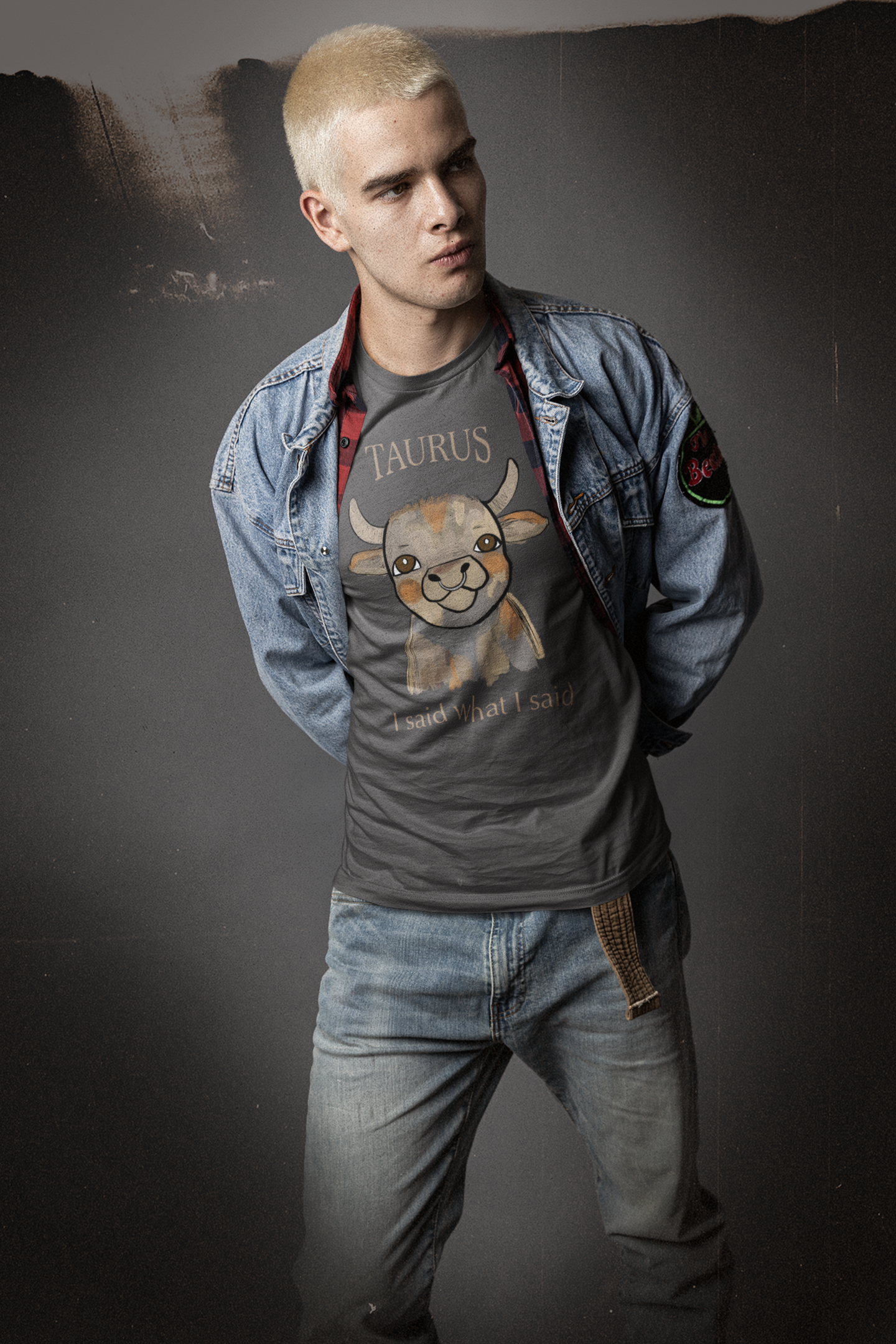 Man with bleached hair in denim jacket wearing a dark heather grey Taurus Bull t-shirt
