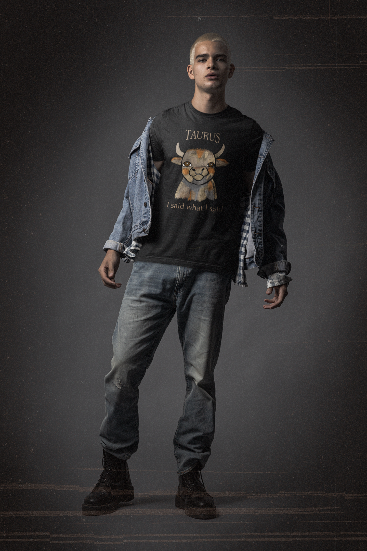 Man with bleached hair standing in grunge outfit wearing a black Taurus Bull t-shirt