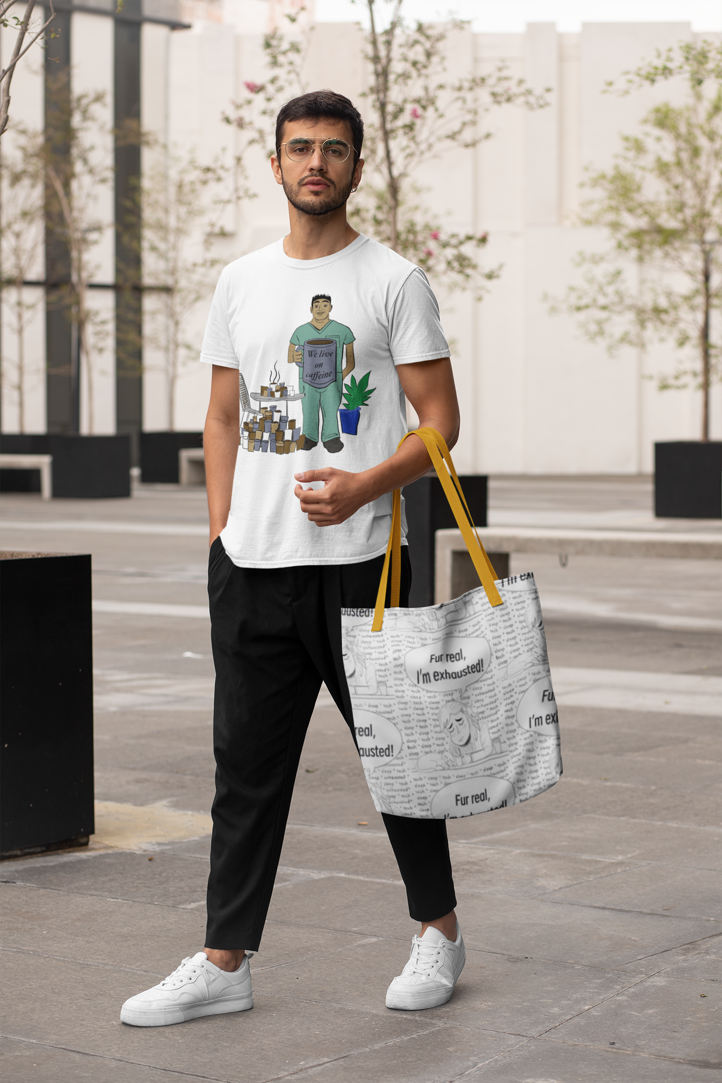 Man with glasses and white We Live On Caffeine t-shirt holding a black and white Fur Real, I'm Exhausted tote bag with yellow straps outdoors