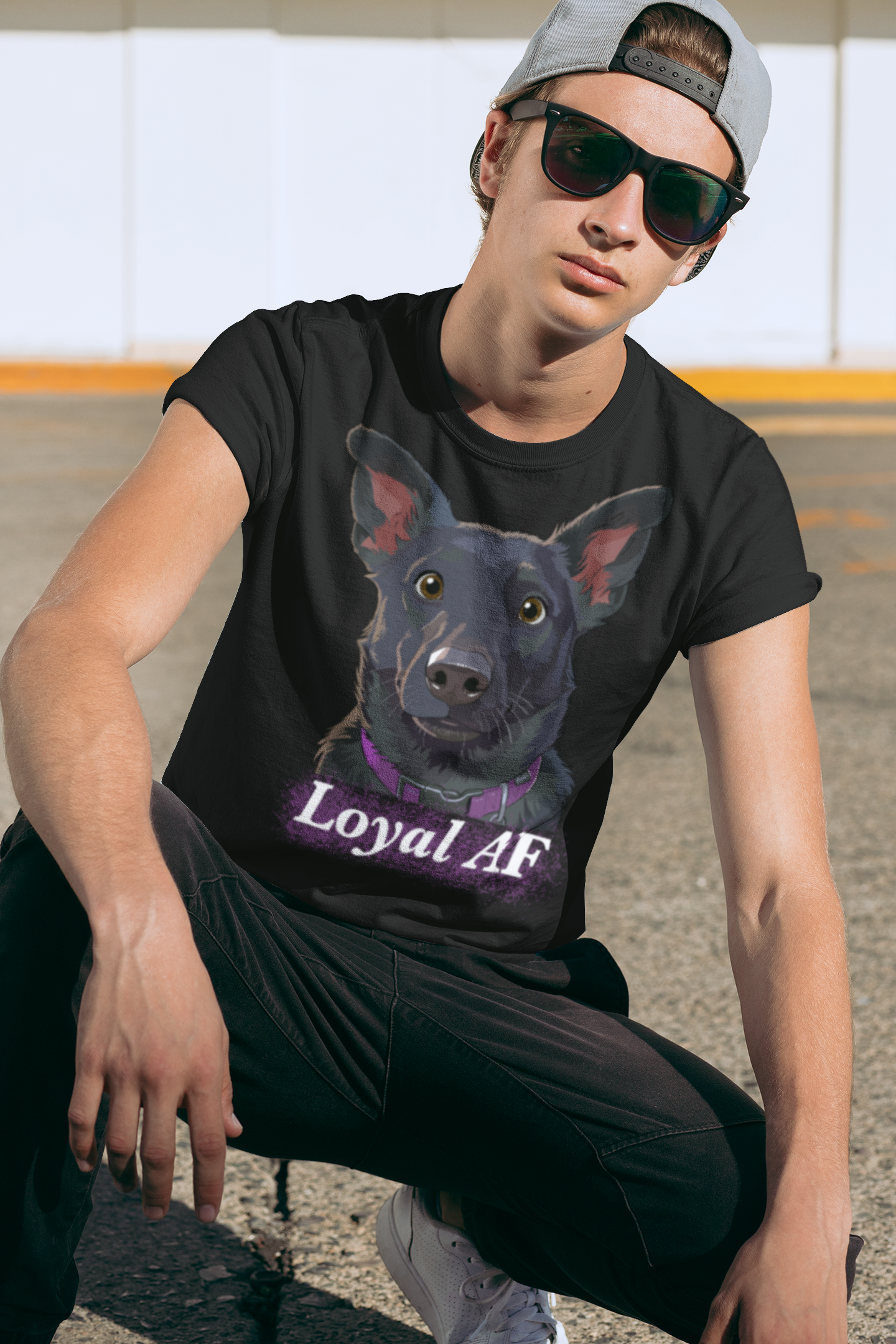 Man with sunglasses crouching outdoors wearing a black t-shirt featuring the Mathis Loyal AF design