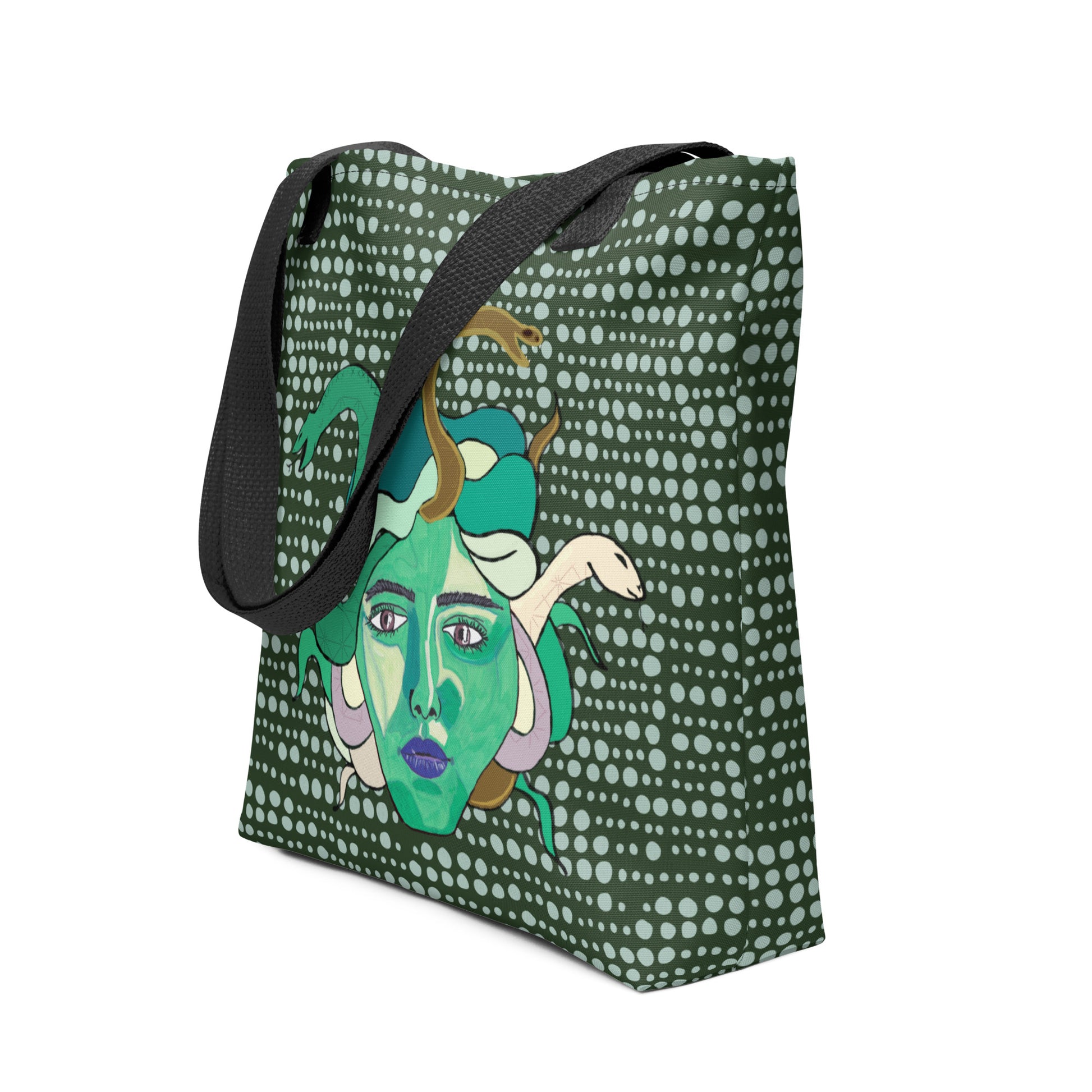 Side angle of the Medusa all-over print tote bag showing the dark green dotted background and black strap by GrungePup Gallery