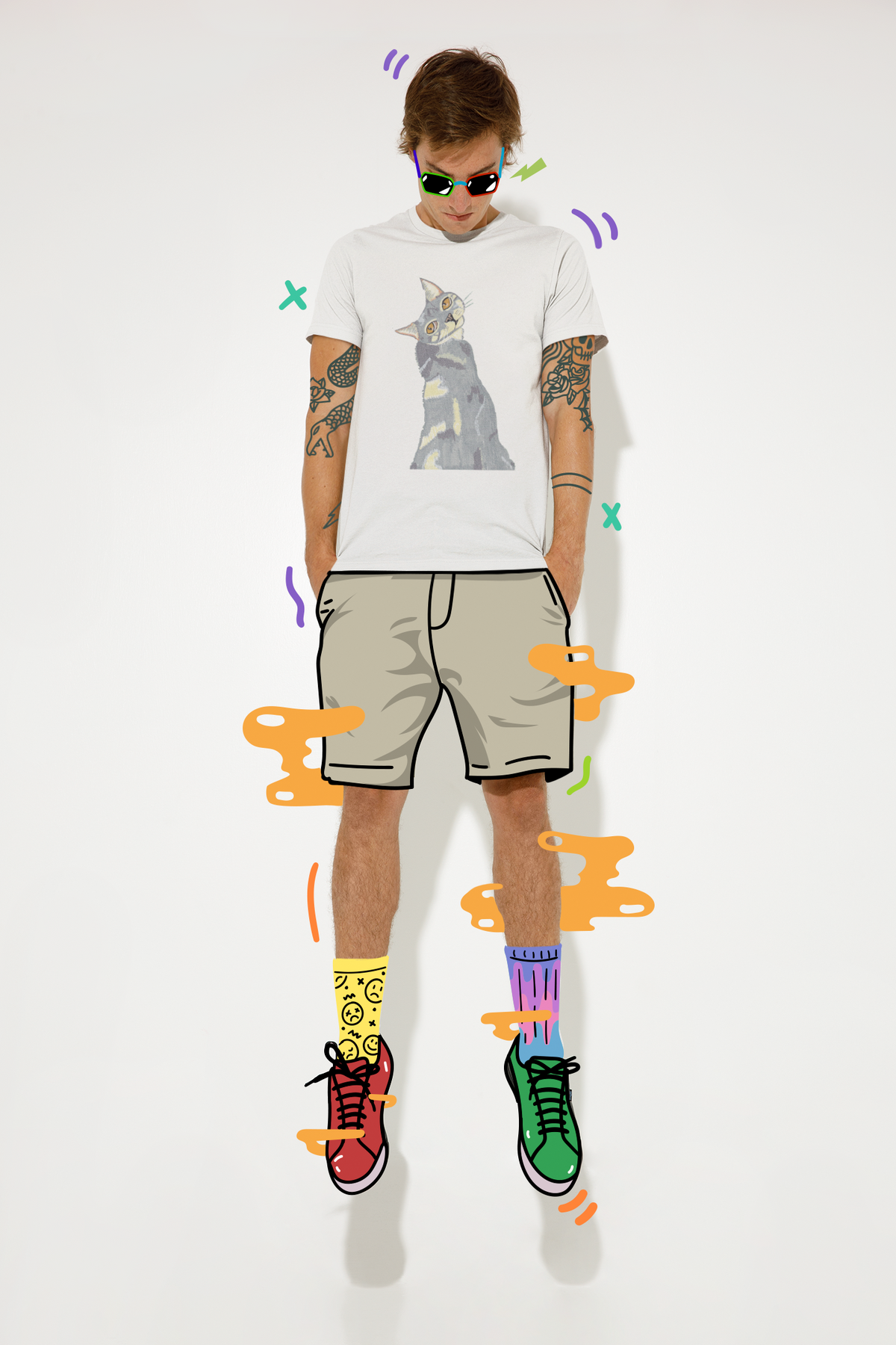 Man with tattoos wearing the Mr. Grey Cat Portrait T-Shirt in white, surrounded by colorful illustrated graphics and floating elements.