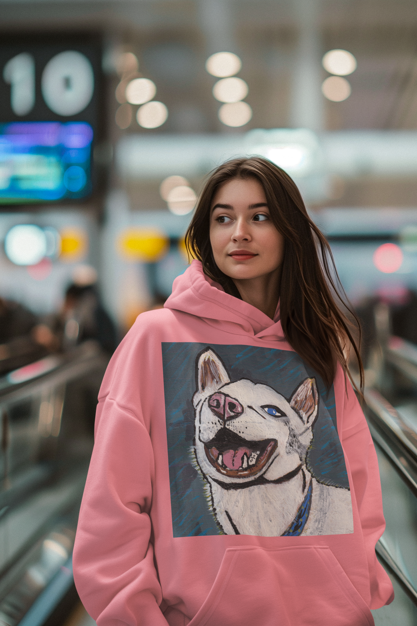 Woman wearing azalea pink Nico Face hoodie with colorful Nico husky design