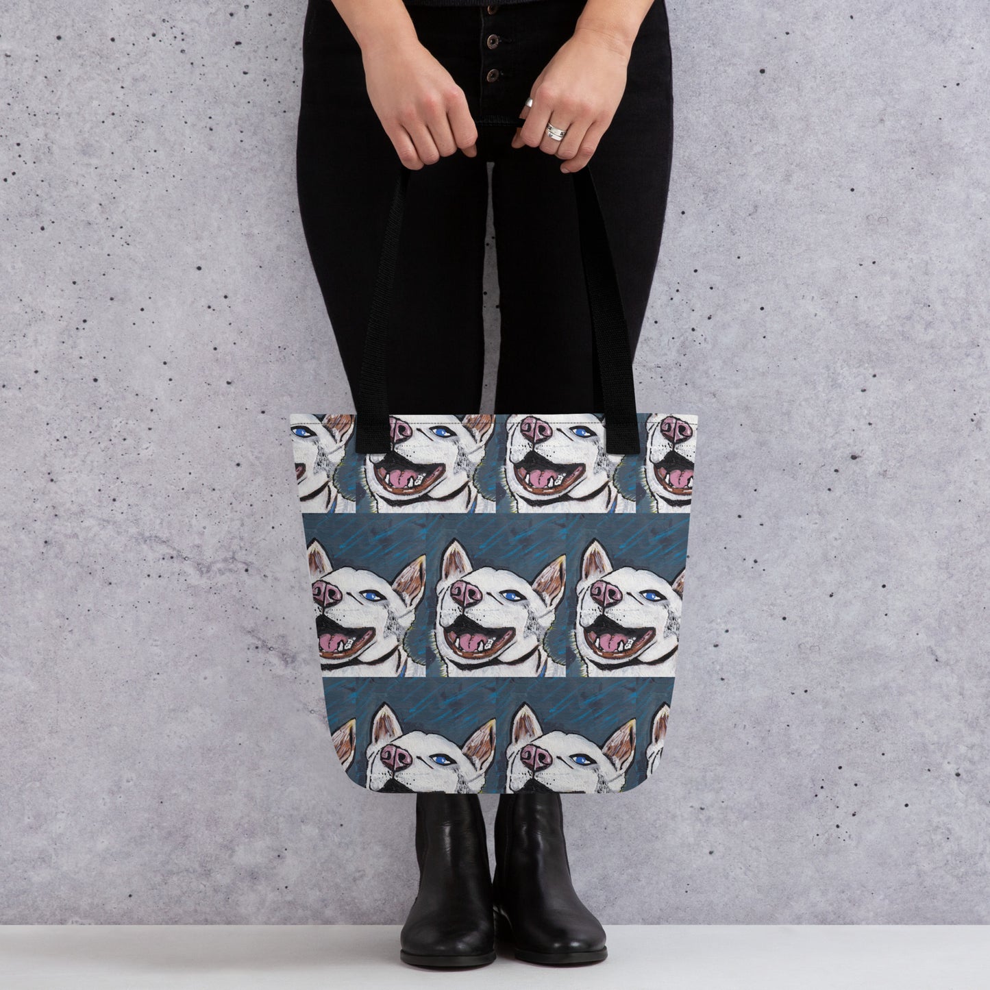 Woman standing indoors carrying Nico Face all-over print tote bag