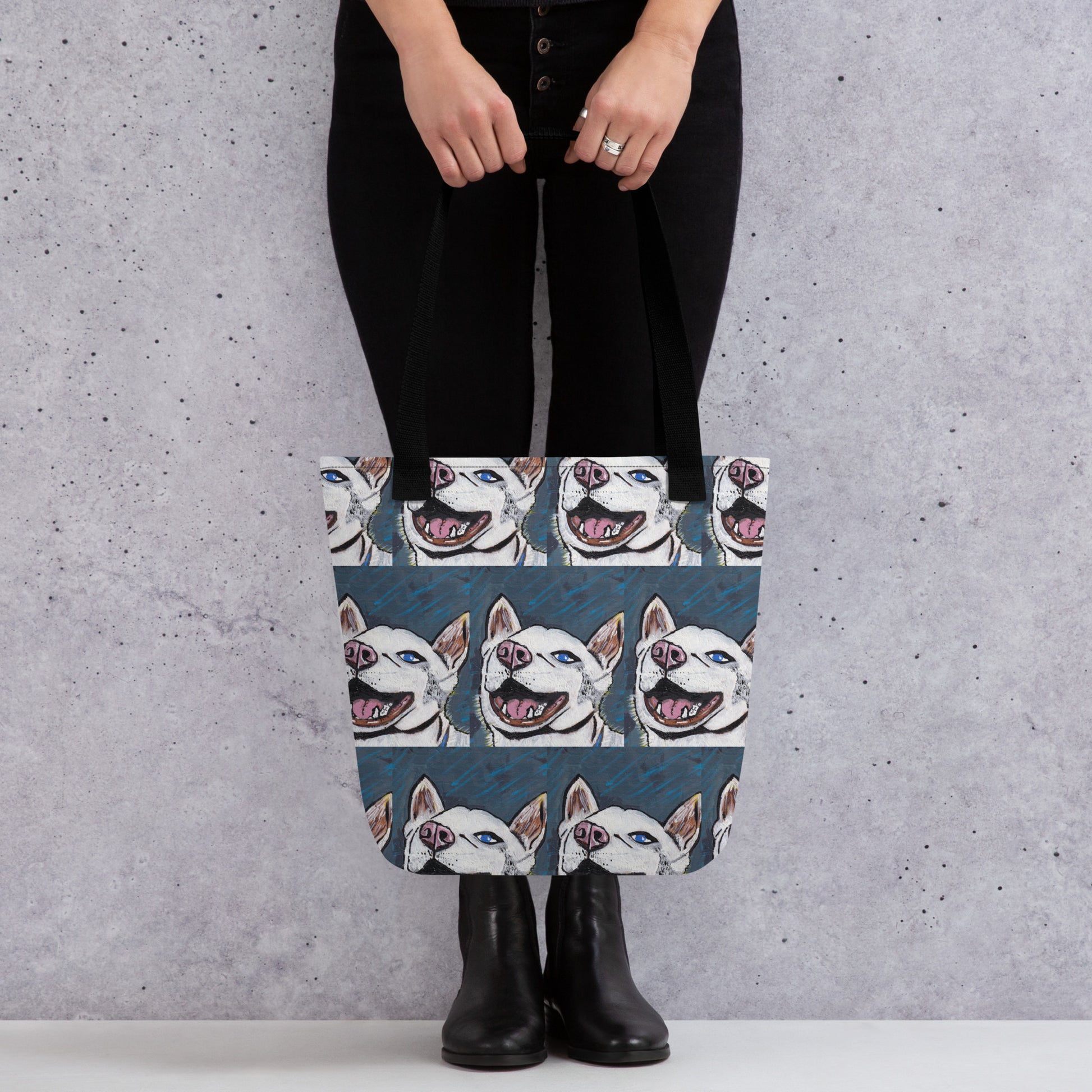Woman standing indoors carrying Nico Face all-over print tote bag