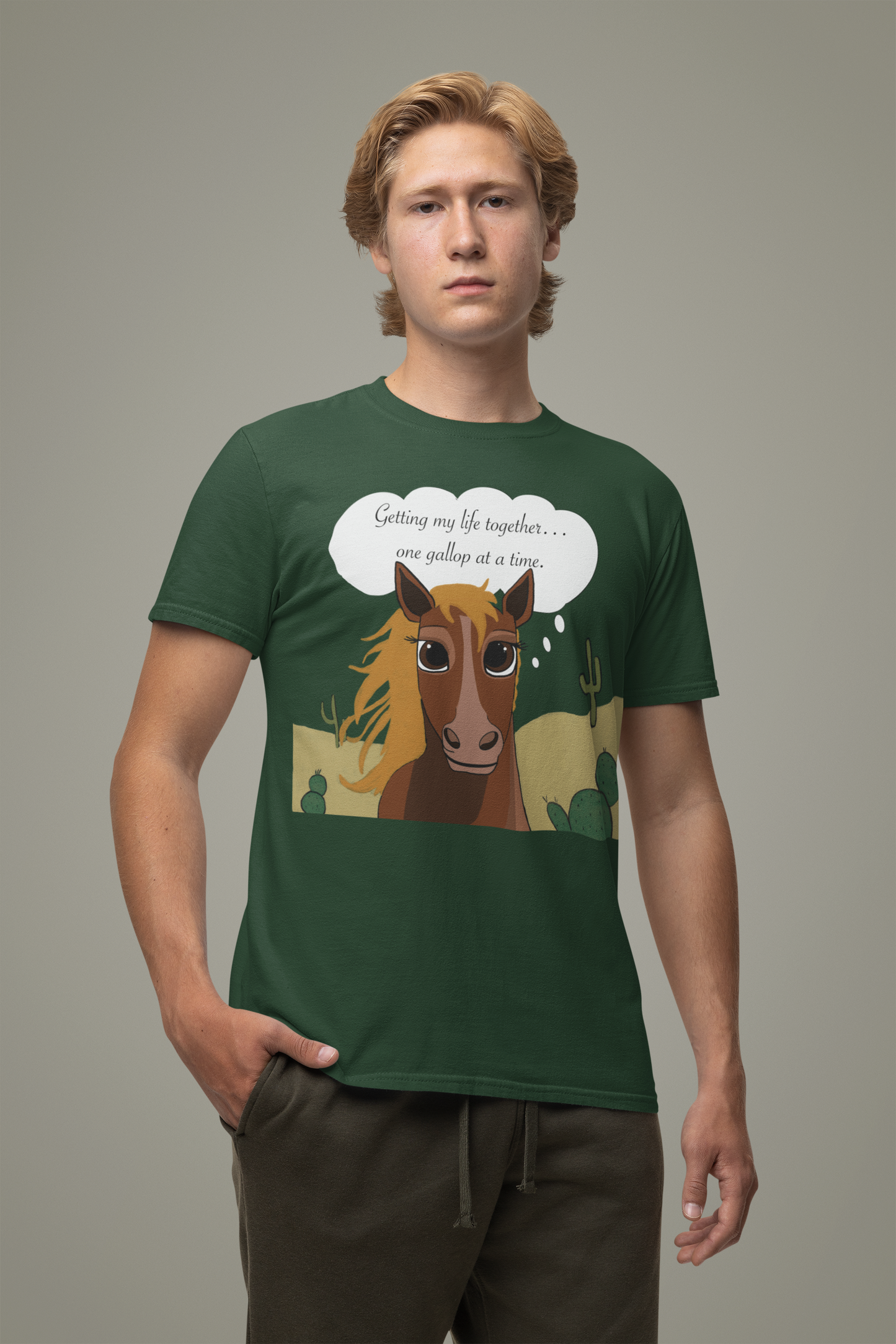 Man wearing forest green One Gallop at a Time t-shirt posing in studio