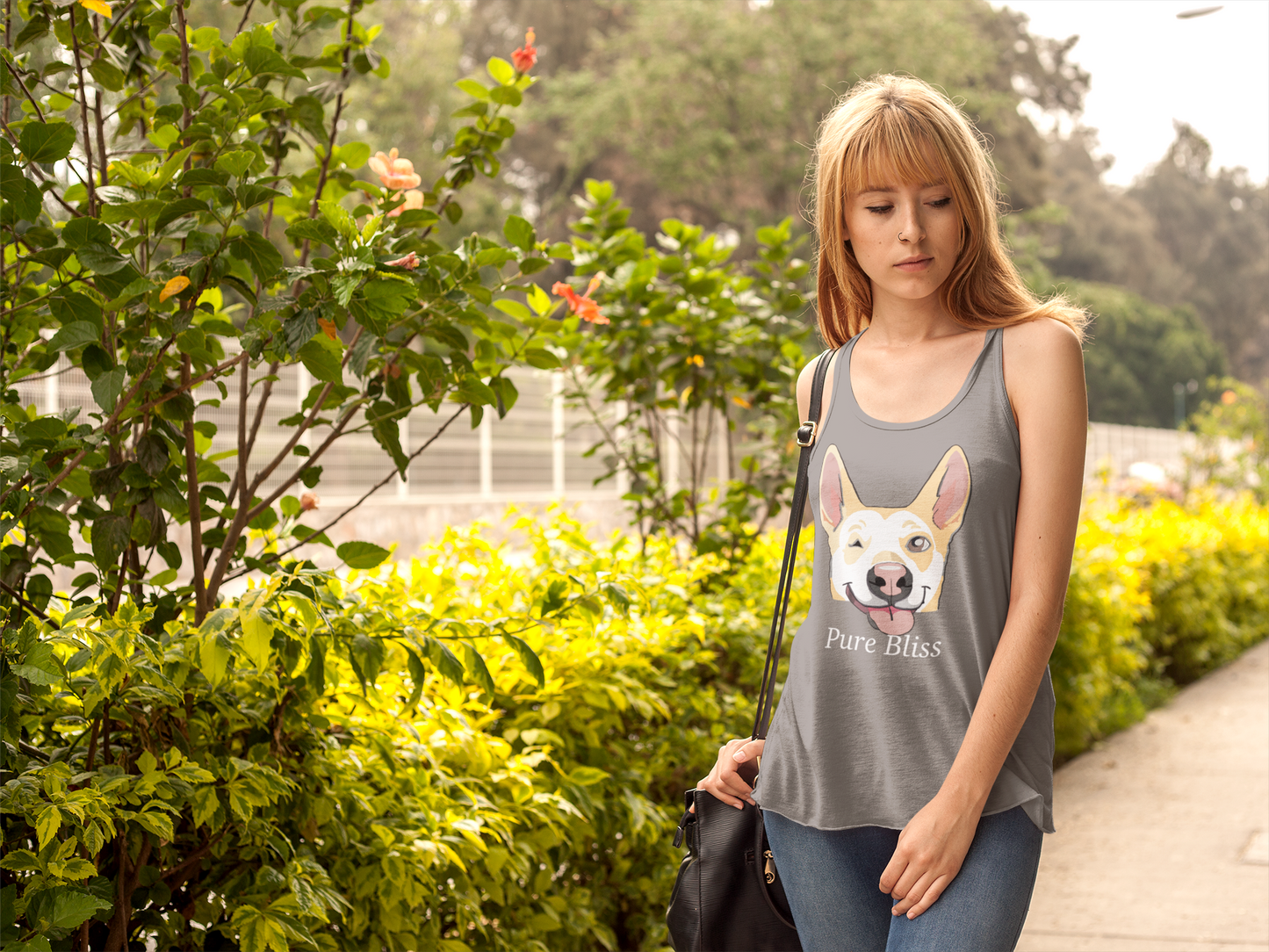 Woman standing in garden wearing premium heather gray Pure Bliss Nico Face racerback tank top