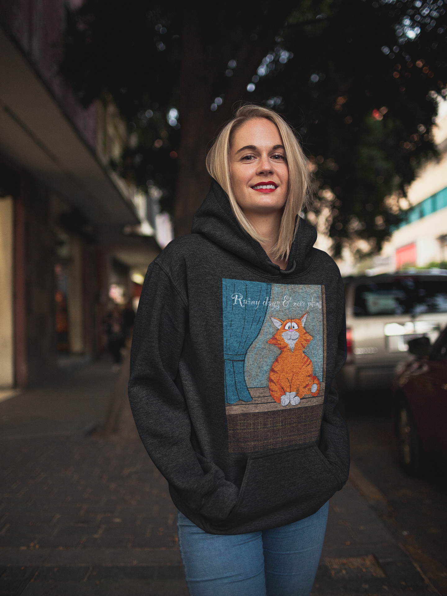 Woman standing on the street wearing black Rainy Days & Zero Plans cat hoodie