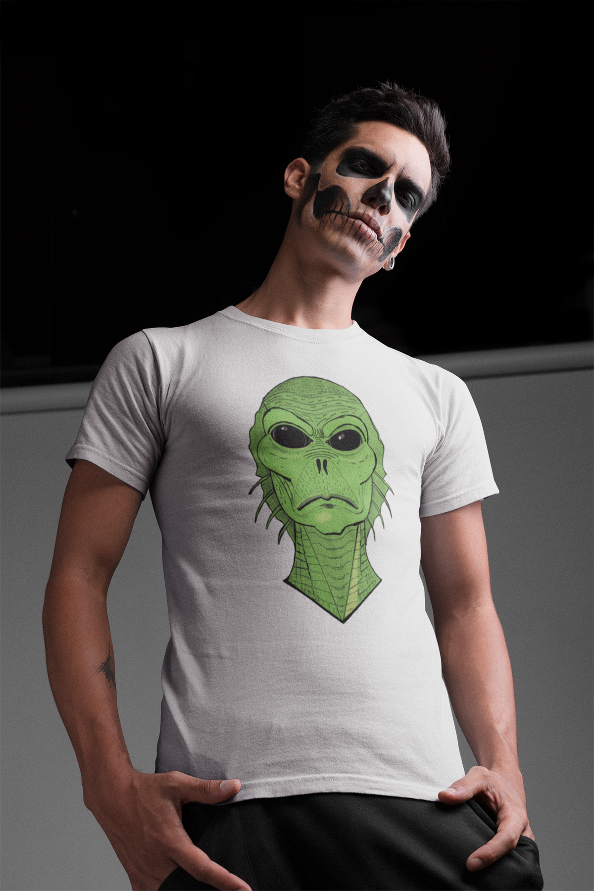 Man with skeleton face makeup wearing a white t-shirt with the Swamp Thang creature face