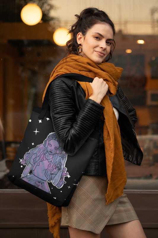 Woman wearing black leather jacket and orange scarf carrying That Girl, Alice all-over print tote bag with grunge-cute Wonderland design. Whimsical, edgy, and self-taught art for the dreamers who know the real adventure.
