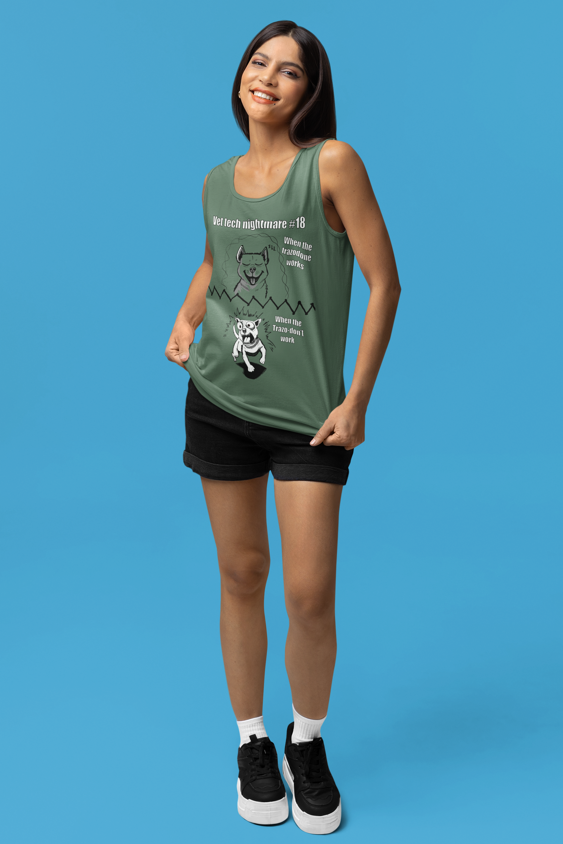 Cheerful woman posing in studio wearing a light green Comfort Colors 9360 tank top displaying Vet Tech Nightmare #18.