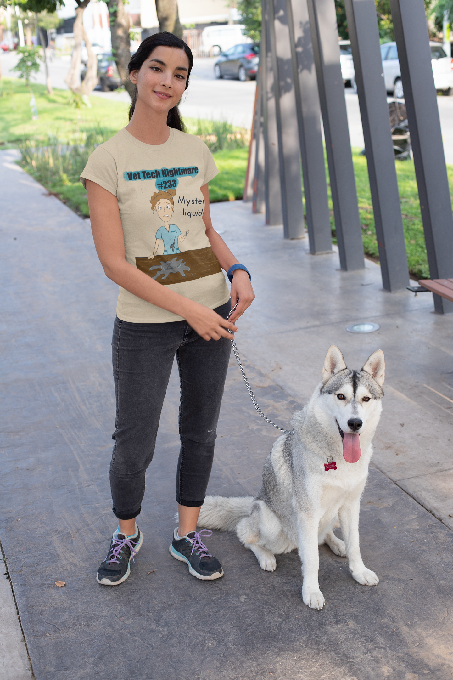 Woman walking husky wearing sand colored t-shirt with Vet Tech Nightmare #233 Mystery Liquid graphic
