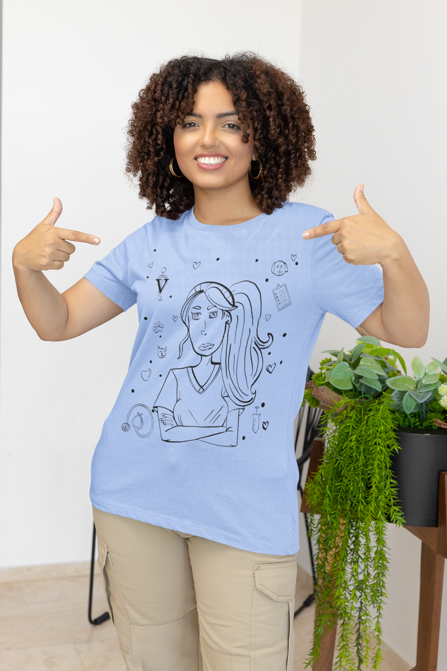 Woman in heather carolina blue "Vet Vibe Girl" t-shirt with vet tech illustration – GrungePup Vet Chaos funny veterinary tee
