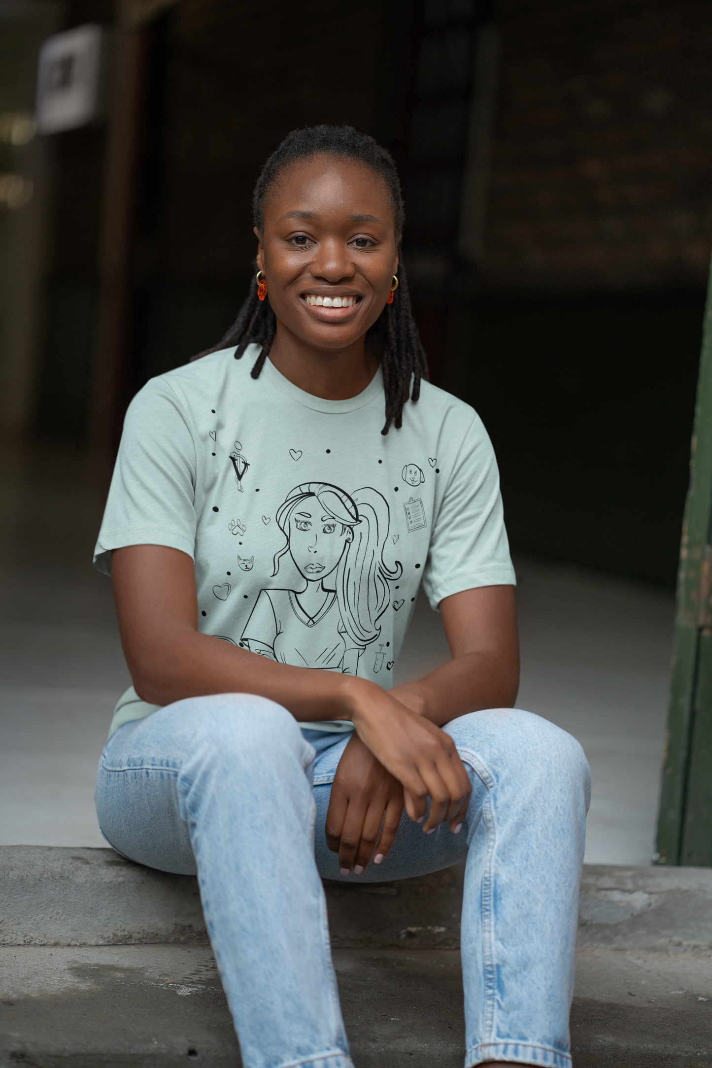 Woman wearing heather prism ice blue "Vet Vibe Girl" t-shirt with headphones and vet tech design – GrungePup Vet Chaos fun vet med apparel