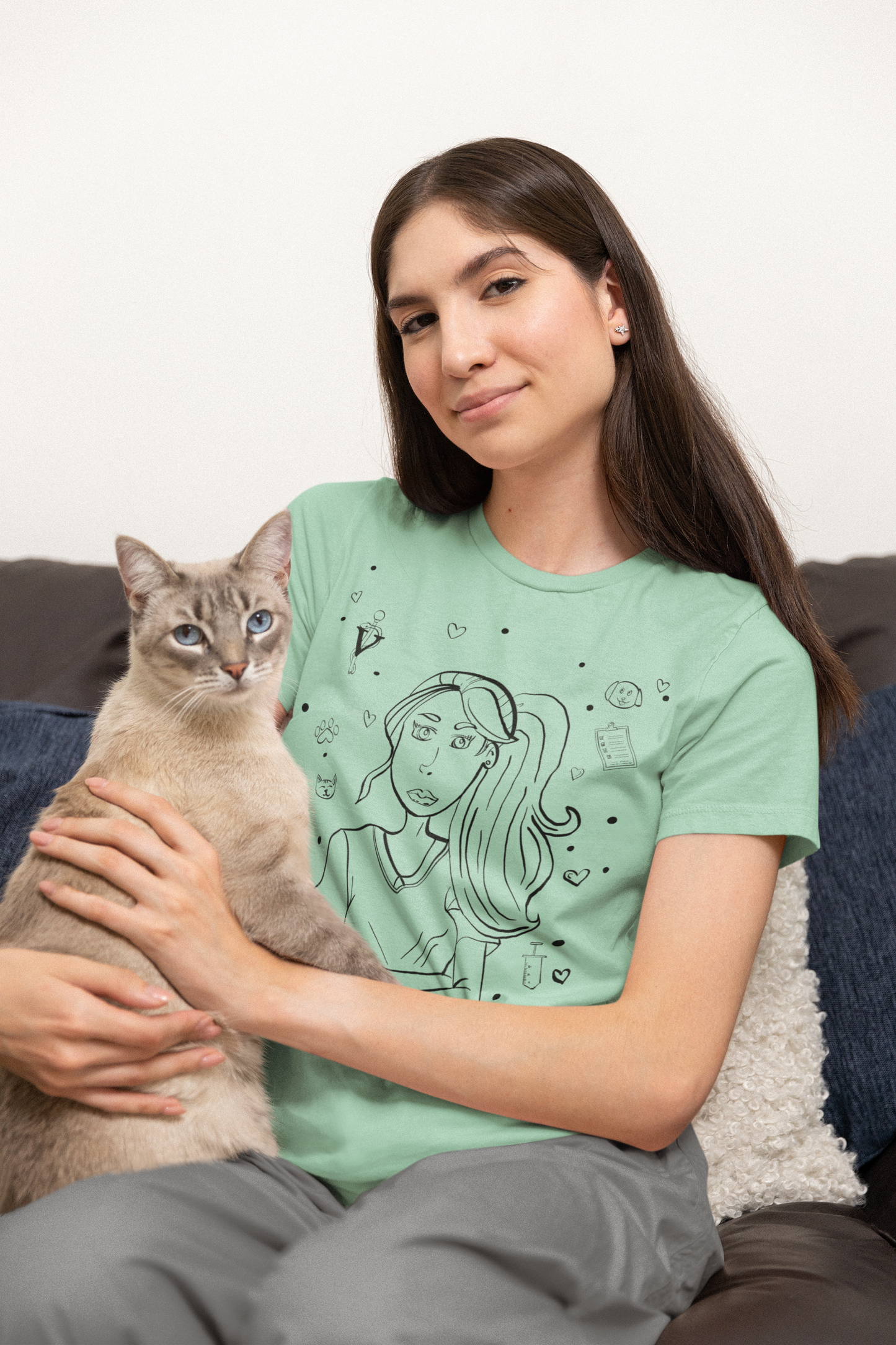 Woman sitting with cat wearing heather prism mint "Vet Vibe Girl" t-shirt – GrungePup Vet Chaos pet-loving veterinary humor