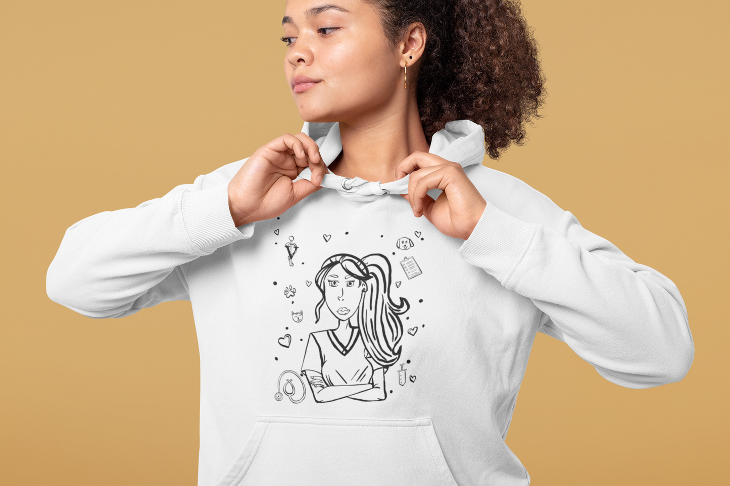 Woman with curly hair looking to the side while adjusting the drawstrings of her white Vet Vibe hoodie featuring the darkened line-art vet girl design.