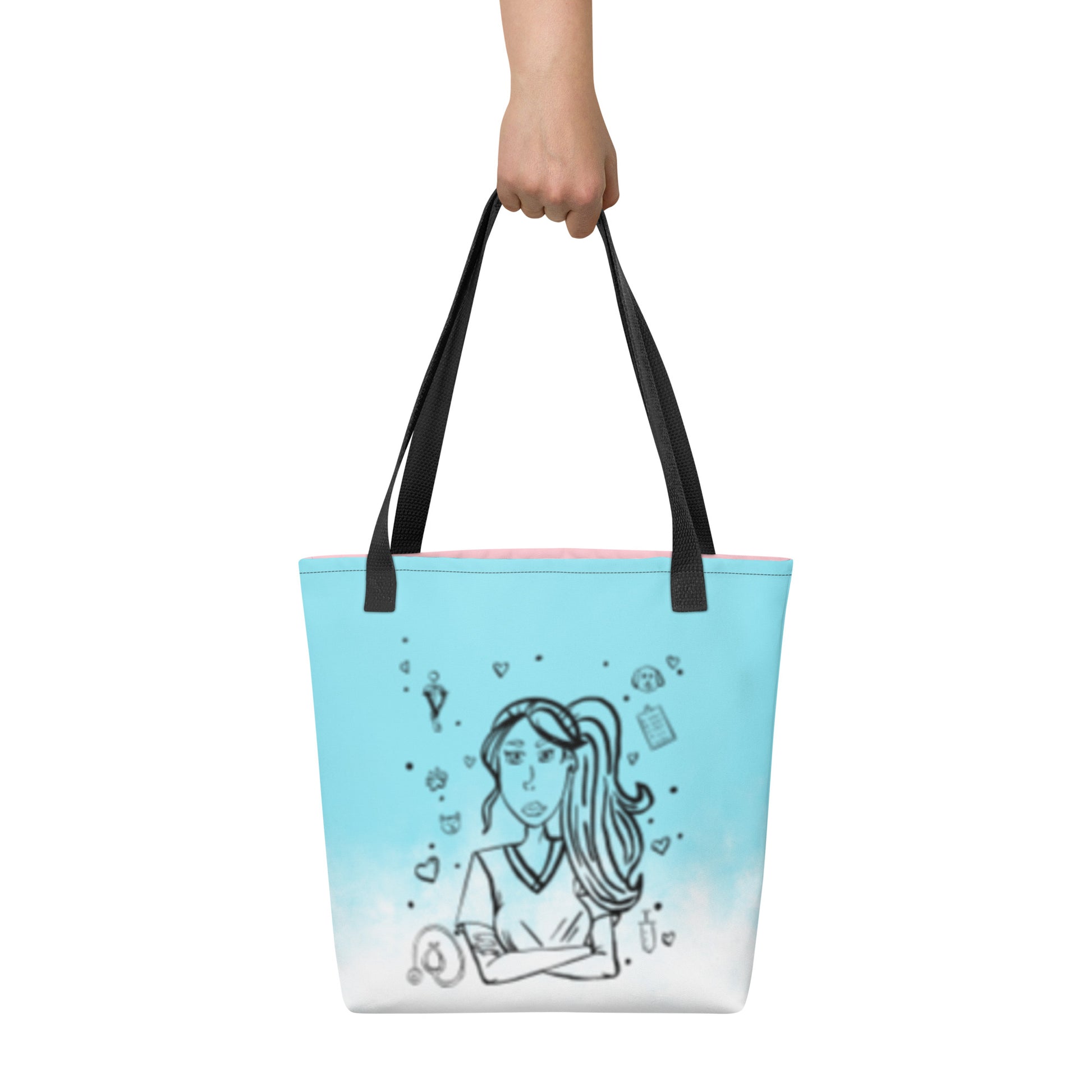 Front view of the Vet Vibe all-over print tote bag in blue featuring the darkened line-art vet girl design with hearts, paw prints, and medical icons, held by a hand against a white background.